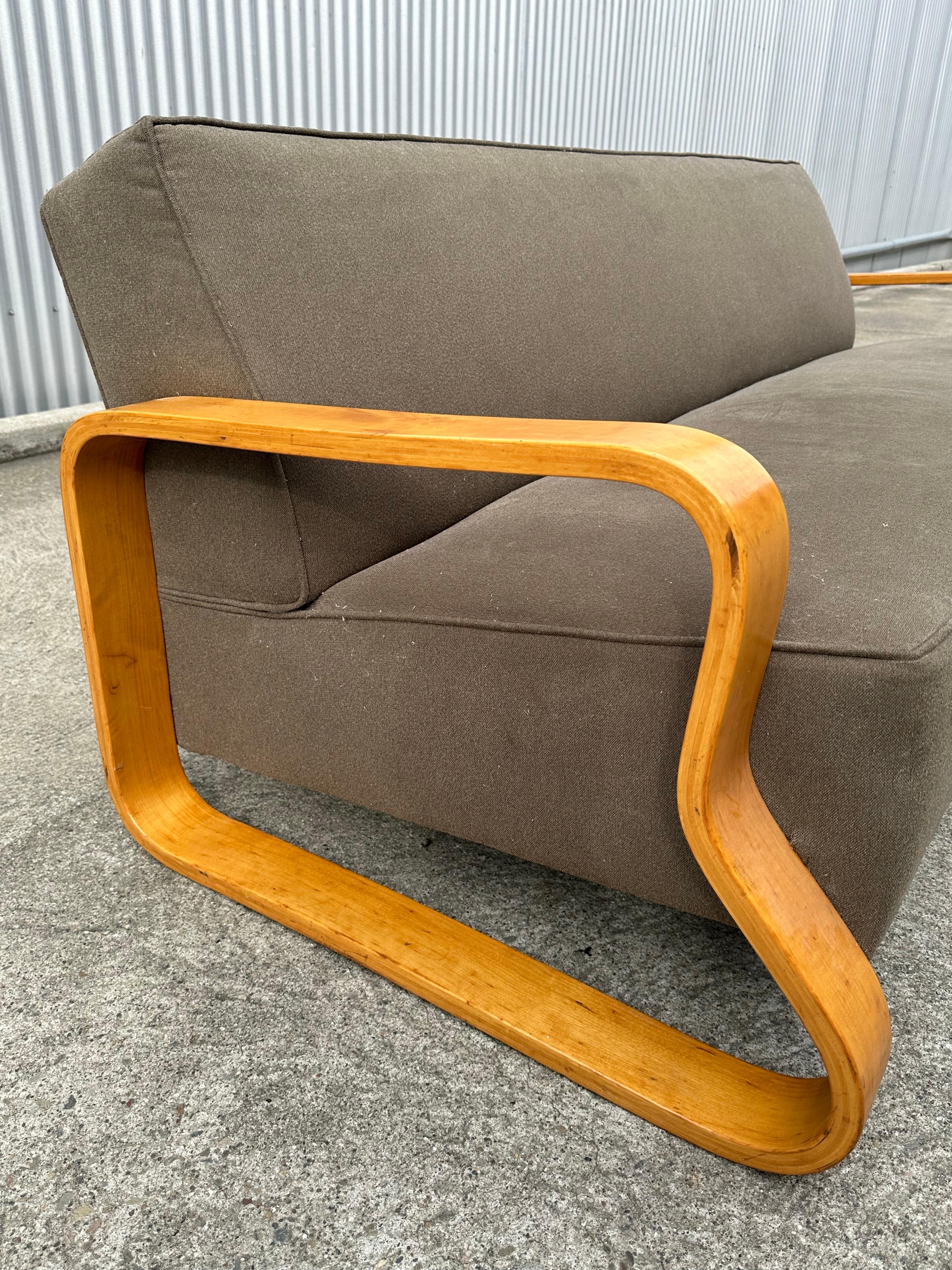 Rare original Alvar Aalto Paimio sofa design circuit 1932 by Finmar, Finland. Spectacular bent plywood frame, recent neutral green micro chenille upholstery great as a placeholder. Lends itself to reupholstering.
Frame has undergo finishIng in the