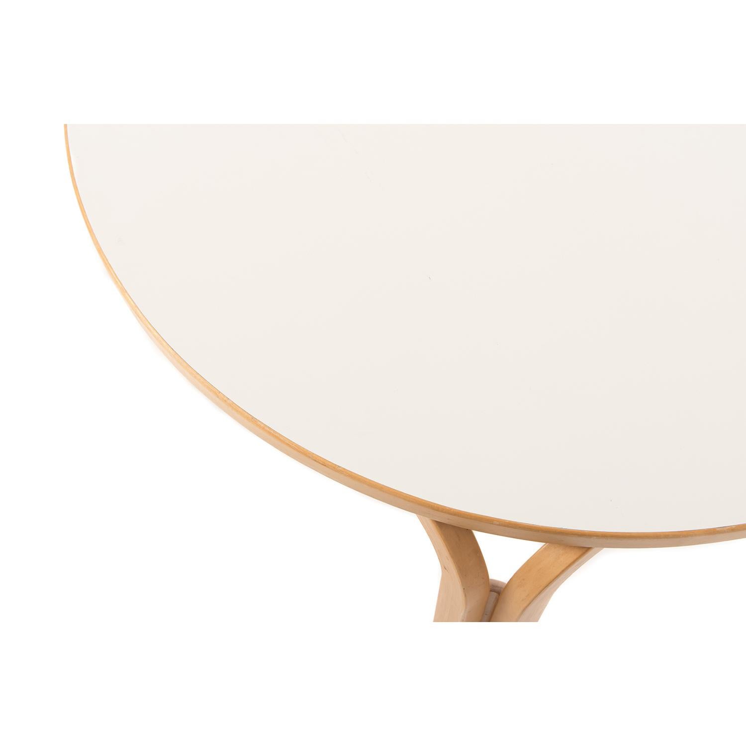 Scandinavian modern round beech dinette table with white laminate top. Great for a sunny breakfast spot!  