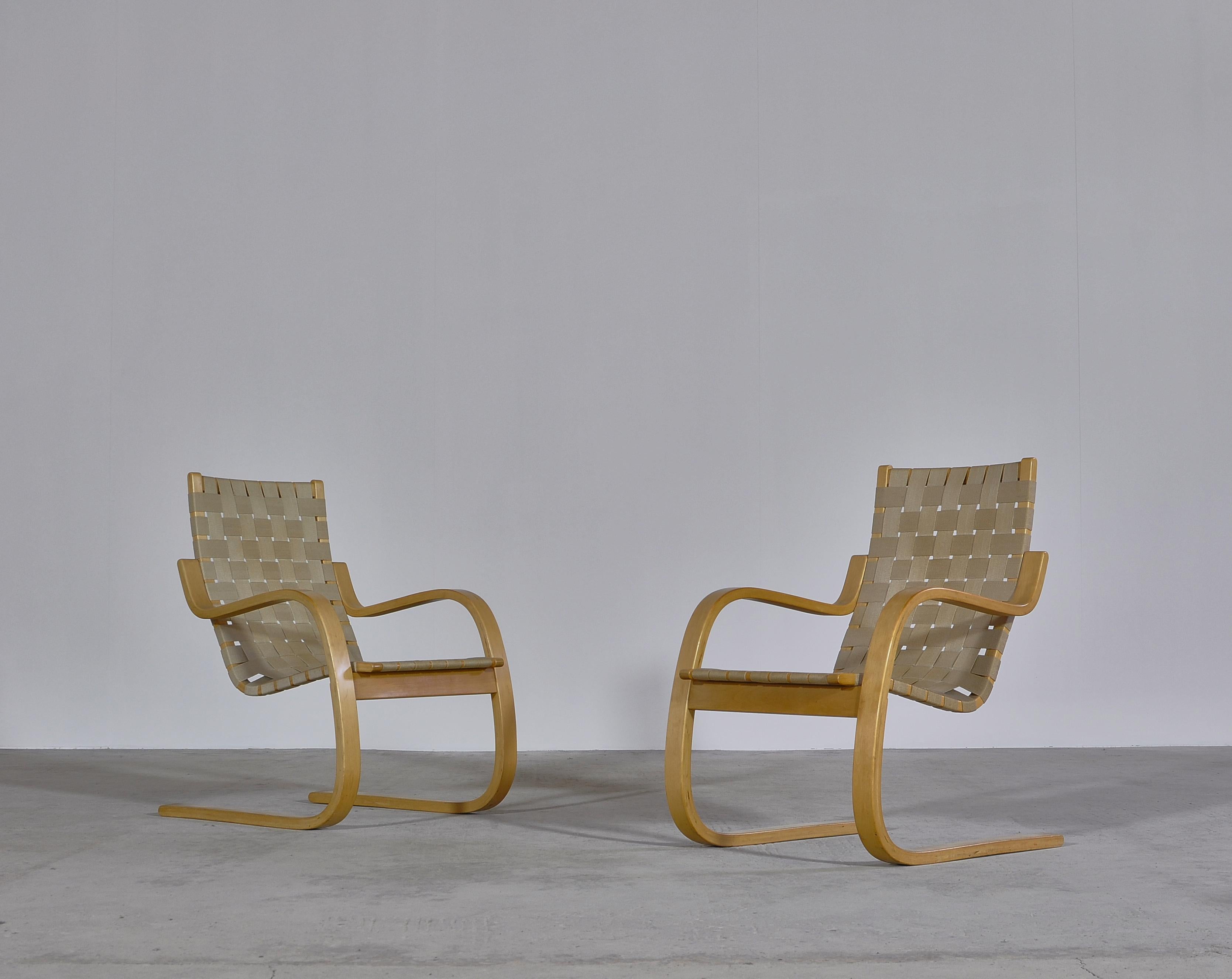 Early pair of Alvar Aalto cantilever chairs model 406 Artek, 1960. Beautiful vintage armchairs made from laminated birch. This is an early production by Artek in original condition with a nice patina to the birch and the canvas webbing.