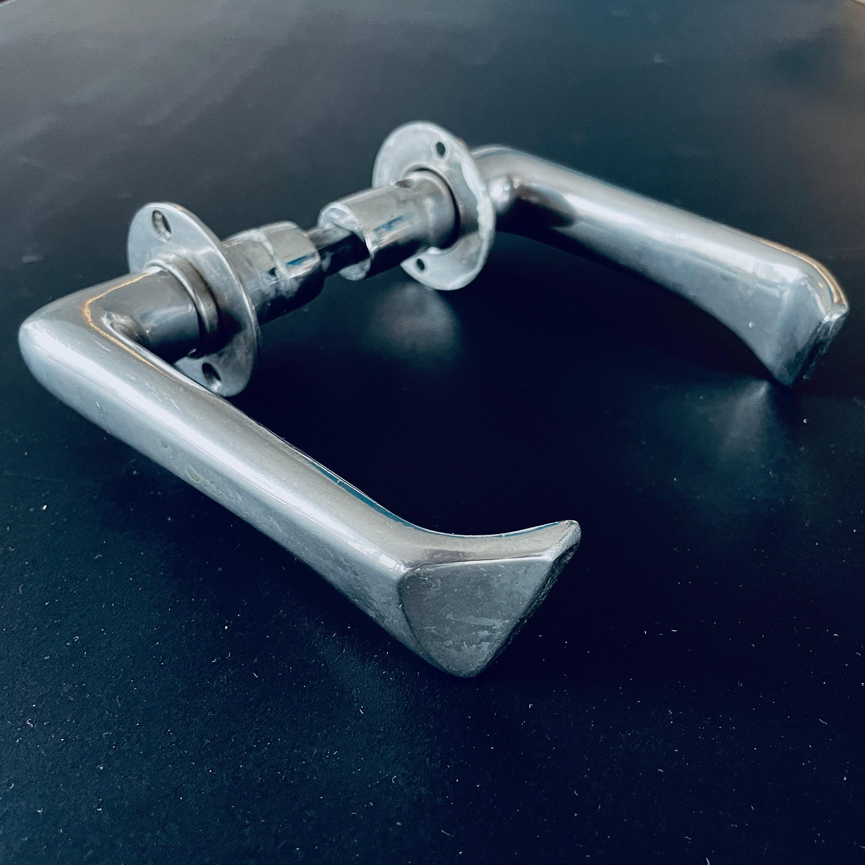 Sculptural Door Handles designed by Alvar Aalto in 1950s. Made in Finland.

Materials: Nickel-plated Bronze.

Includes two handles and spacer. No screws.

Rarely for sale. (Most of the same model are newer and made of aluminum.).