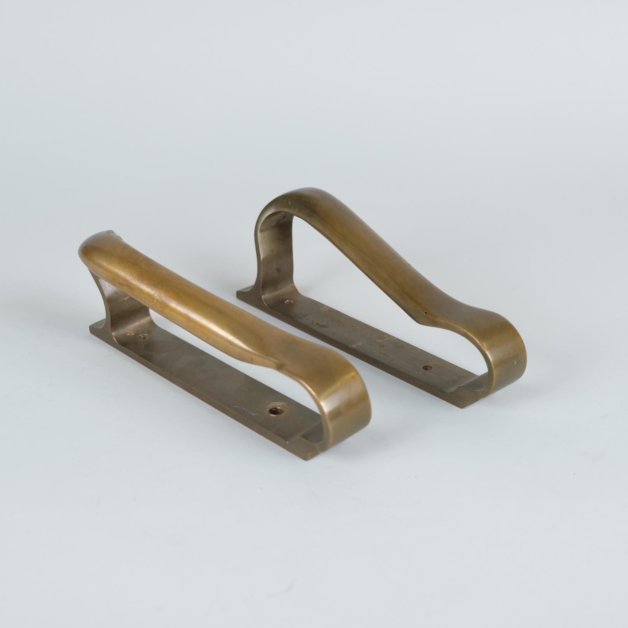 Two sleek, heavy and elegant mid-century door handles in full bronze. Manufactured by valaistustyö and designed by Alvar Aalto himself. Very practical yet stand out as sculptural pieces with guaranteed quality, craftsmanship, authenticity and