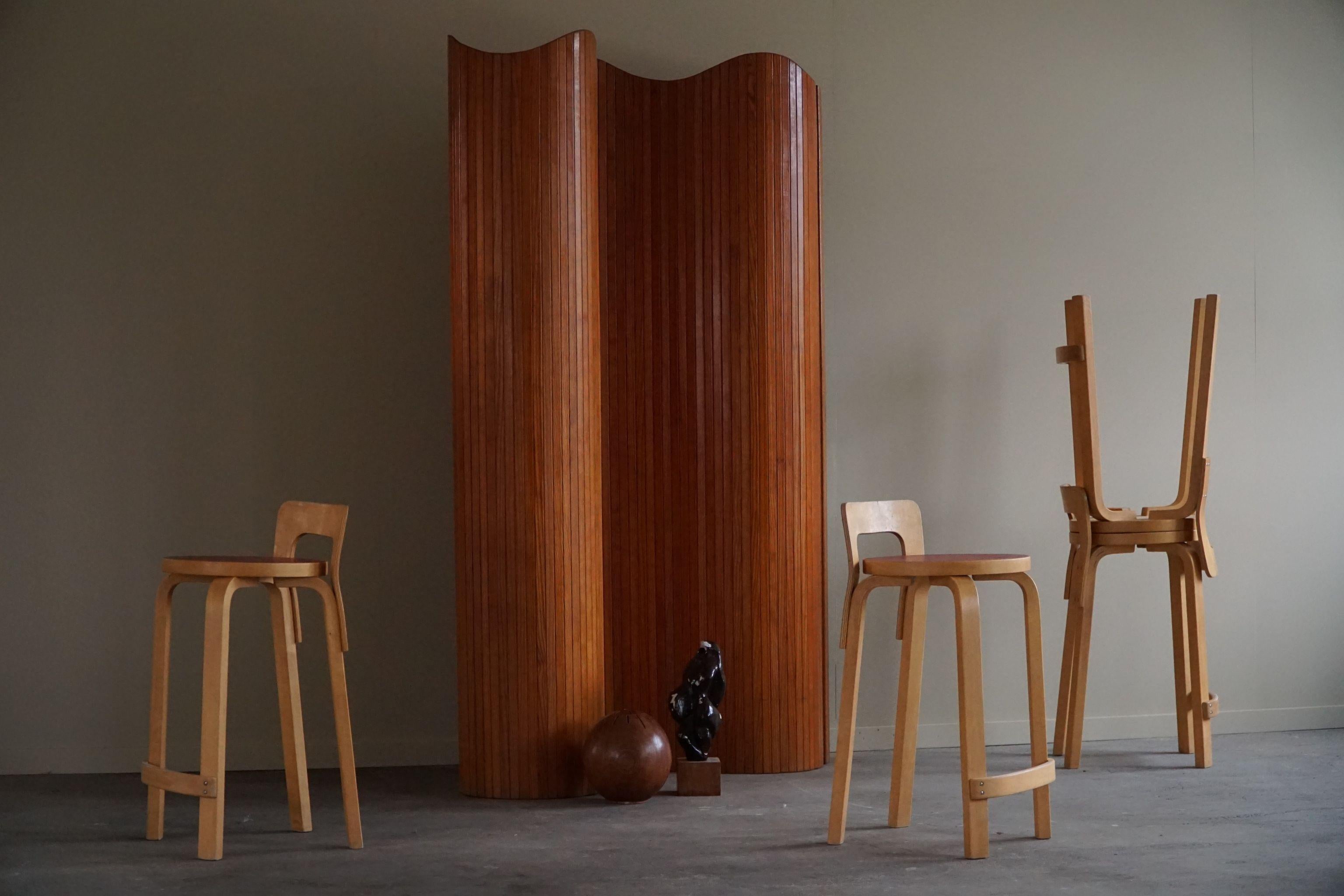 An amazing set of 4 dining chairs in a lacquered birch with red laminate. Designed by Alvar Aalto for Artek in Finland. Model 