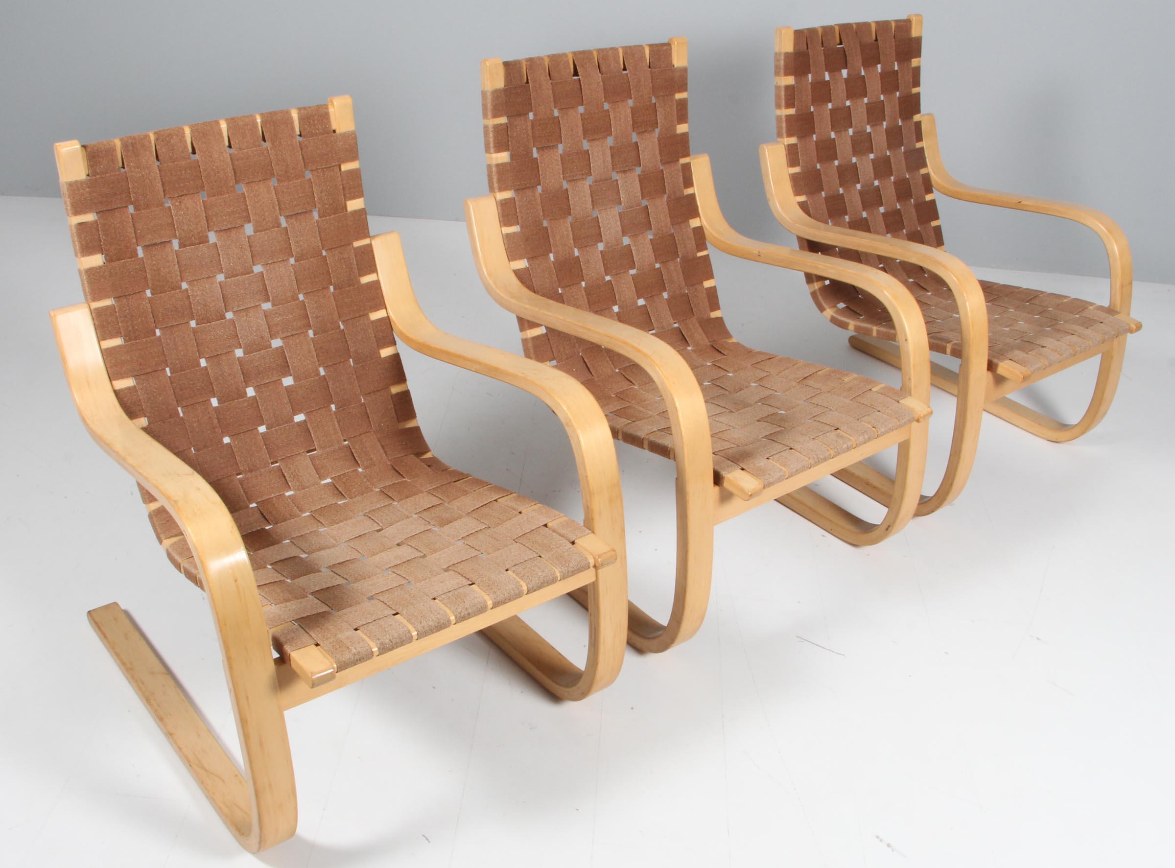 Lounge chairs designed by Alvar Aalto manufactured, circa 1960.

Curved birch plywood and braided vegetable fiber. 

 