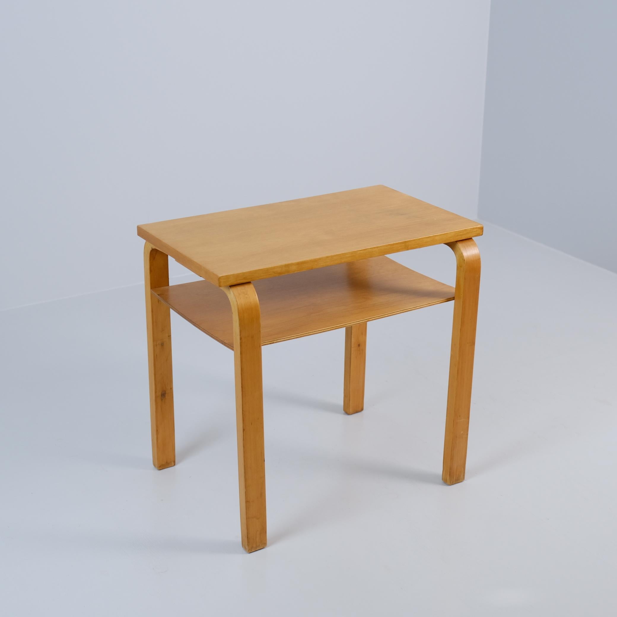 This small size side table can be used in any room, and for a variety of purposes. The shelf feature makes it perfect as an arm chair or reading space side table. The vintage honey like colour patina is absolutely stunning. The table is in very good