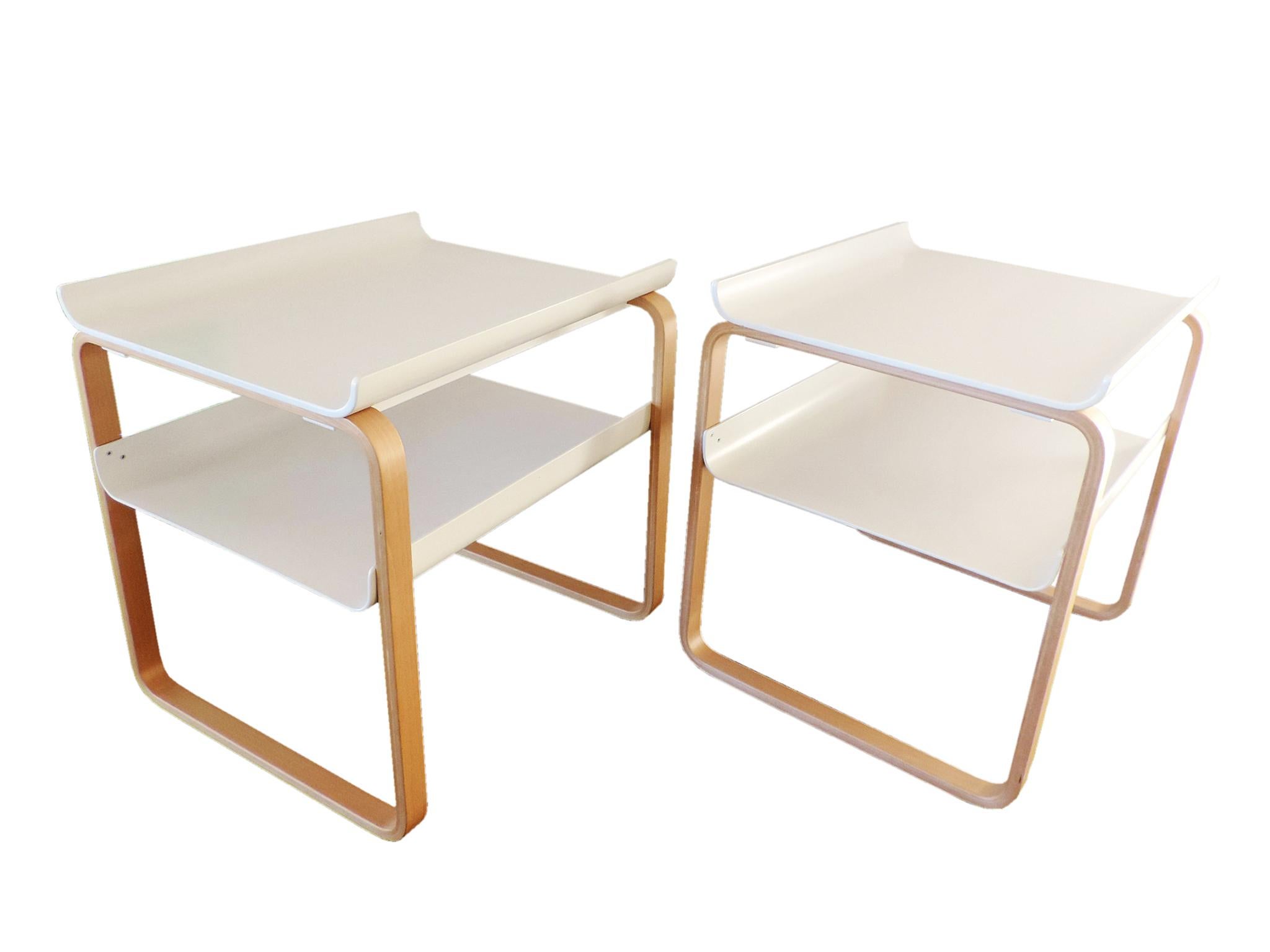 Simple, elegant, timeless Finnish side tables which can be used beside a sofa or used as a bedside tables. 

Hard-wearing white lacquered pressed birch plywood shelves with upturned edges ensure all items remain in place. The laminated birch legs