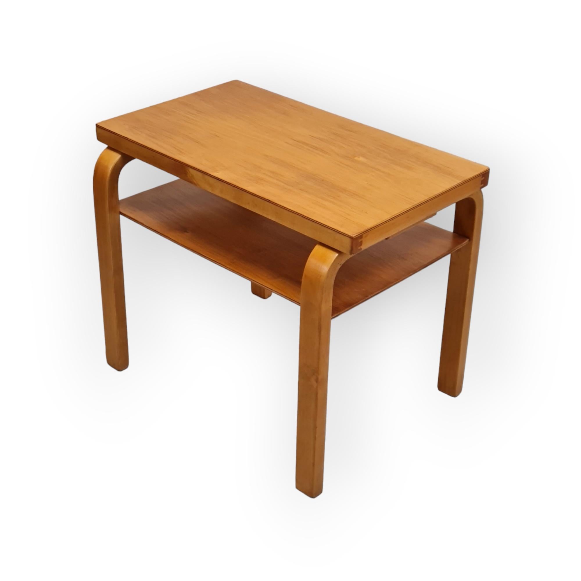 This small size side table can be used in any room, and for a variety of purposes. The shelf feature makes it perfect as an arm chair or reading space side table. The vintage honey like colour patina is absolutely stunning. The table is in very good