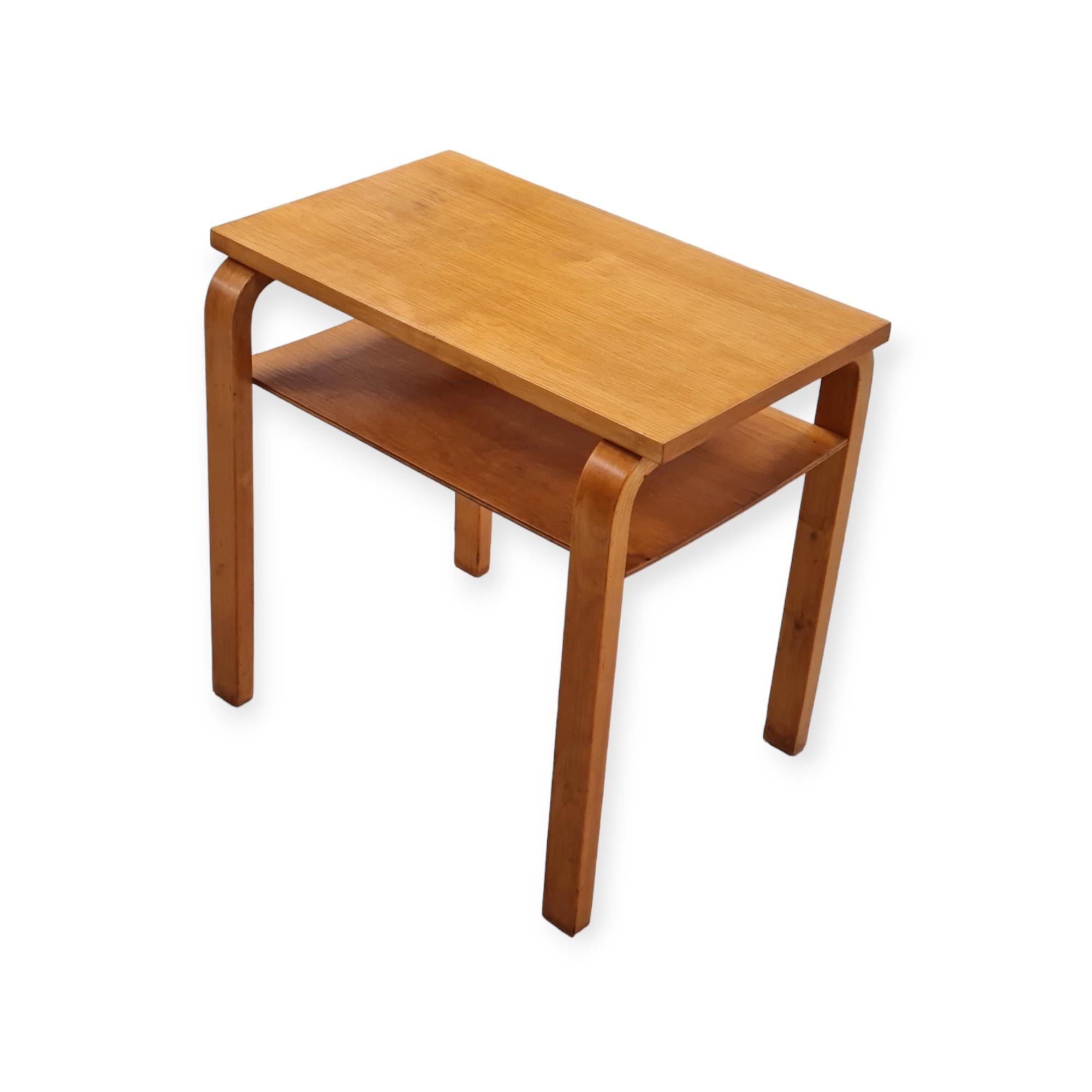 This small size side table can be used in any room, and for a variety of purposes. The shelf feature makes it perfect as an arm chair or reading space side table. The vintage honey like colour patina is absolutely stunning. The table is in very good