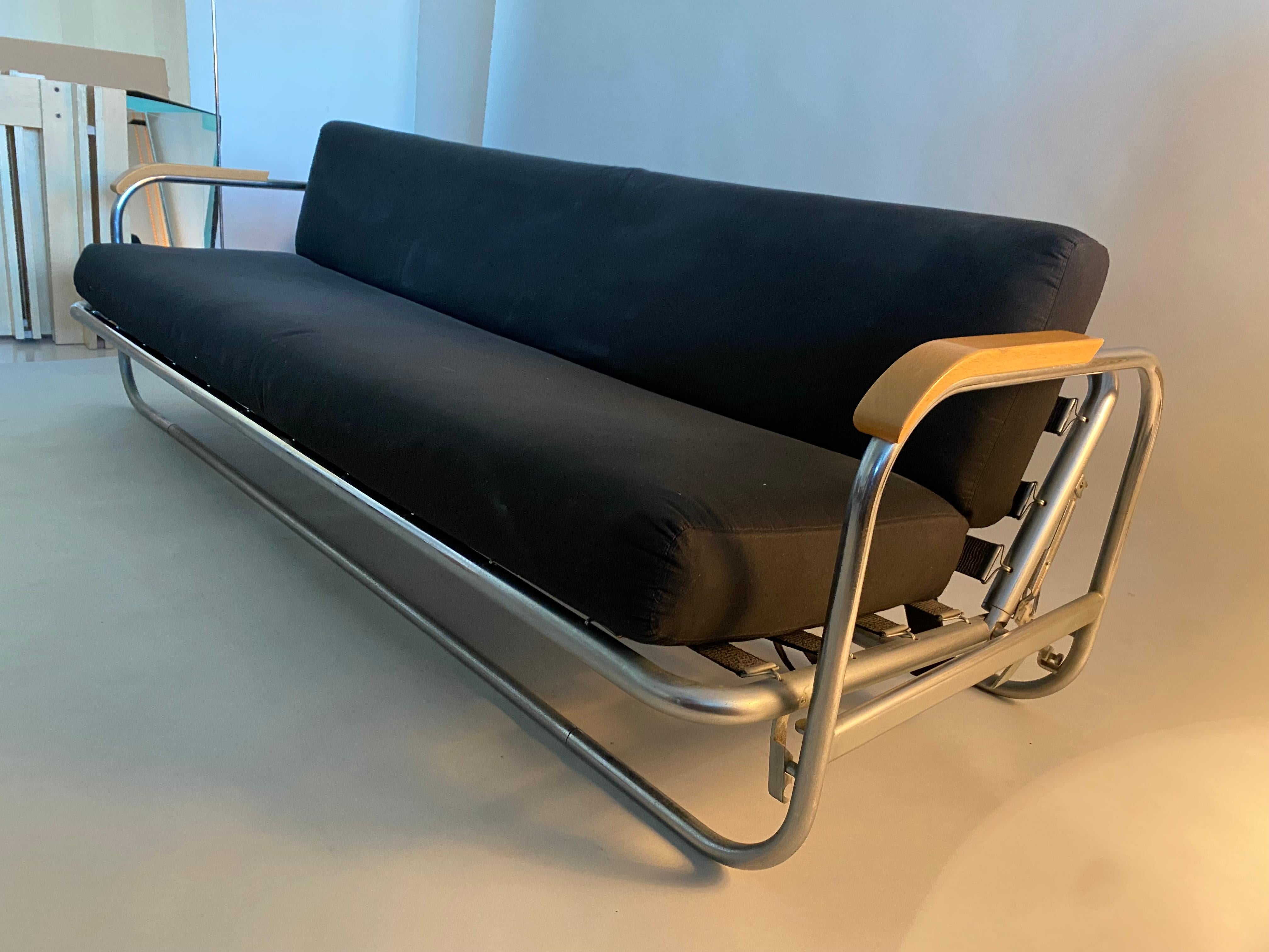 Alvar Aalto Daybed with adjustable seat and back until you get a single bed. It´s made with tubular chromed steel and the armrests are made with wood.
This sofa comes from the 1970s.

 