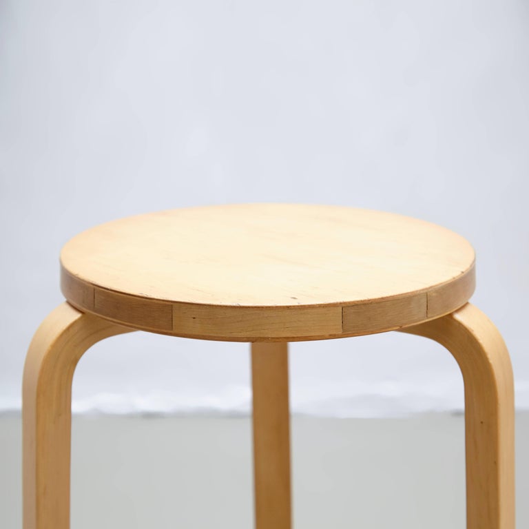 Stool designed by Alvar Aalto, circa 1960.
Manufactured by Artek (Finland).

Wood legs and structure.

In great original condition, with minor wear consistent with age and use, preserving a beautiful patina.

Hugo Alvar Henrik Aalto
