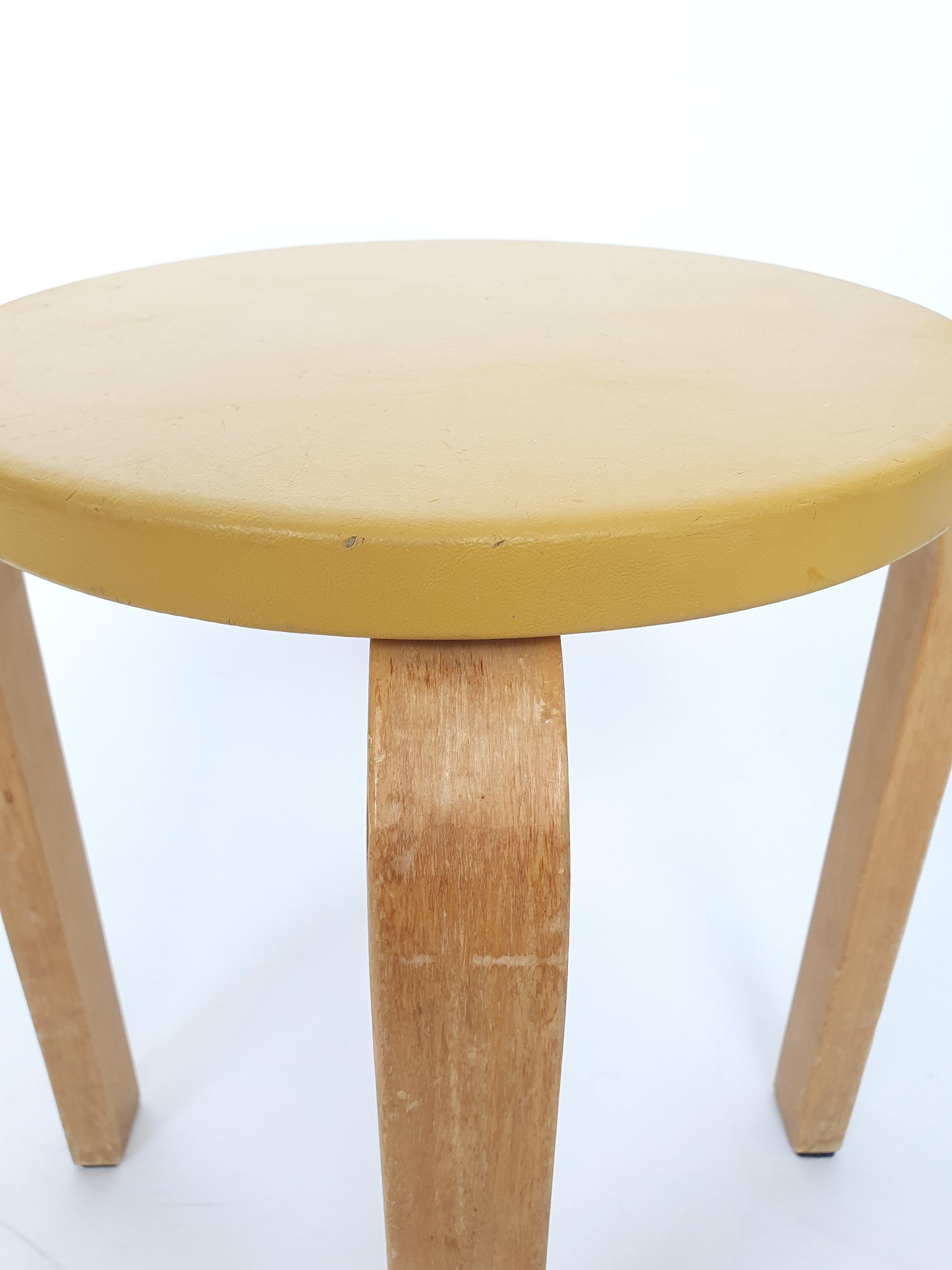 Tabouret Artek E60, design de Alvar Aalto. Magnifique bouleau patiné avec sellerie jaune d'origine. En bon état d'usage. Le tabouret date des années 1960.

Conçu par Alvar Aalto en 1933, le tabouret E60 est un exemple classique de son utilisation