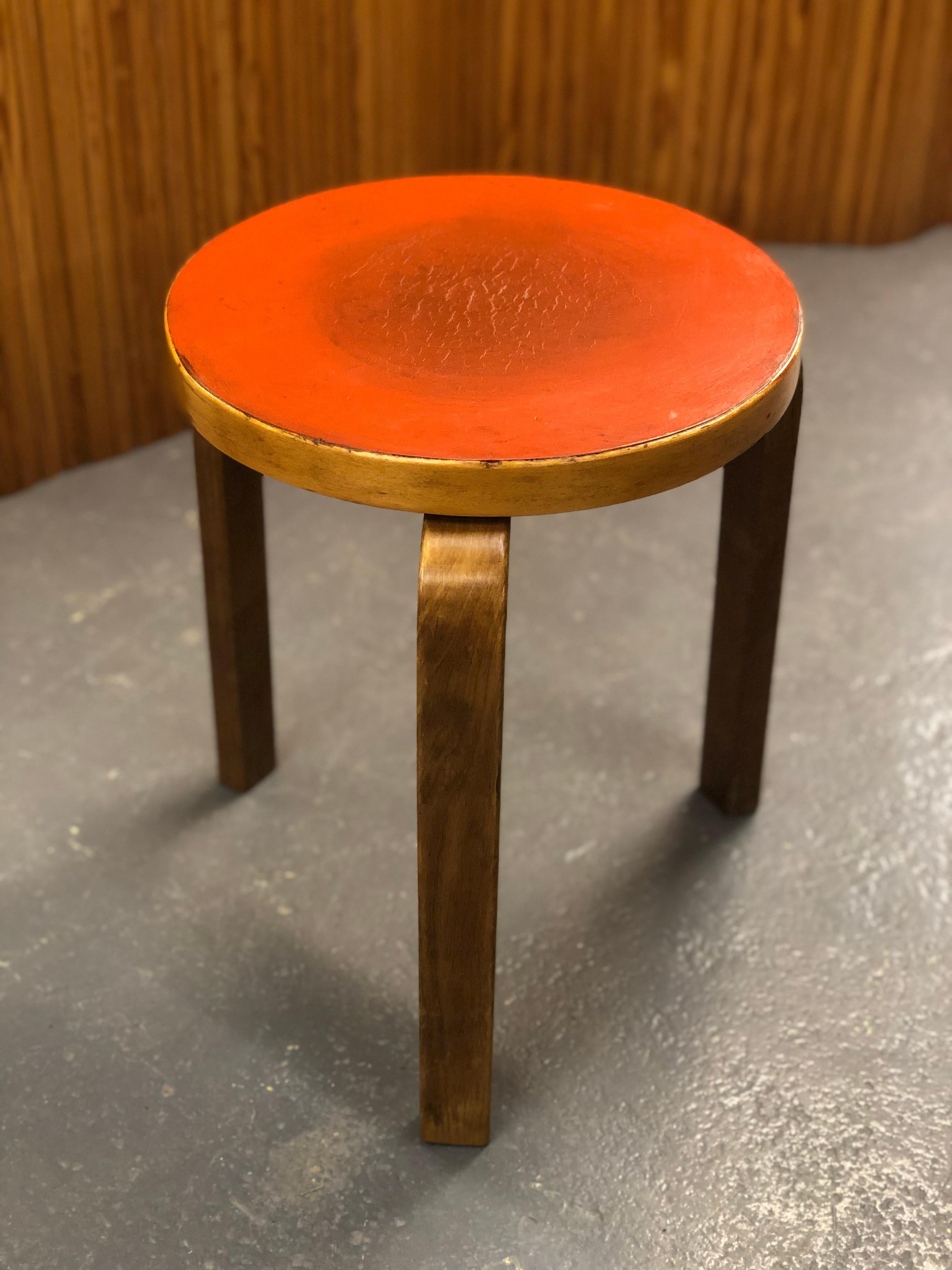 Artek stool in birch and red linoleum, designed by Alvar Aalto and manufactured by Artek in the 1950s. The model 60 stool is perhaps the most well known Aalto design and has always been attractive to people. As with a lot of Alvar Aalto's works the