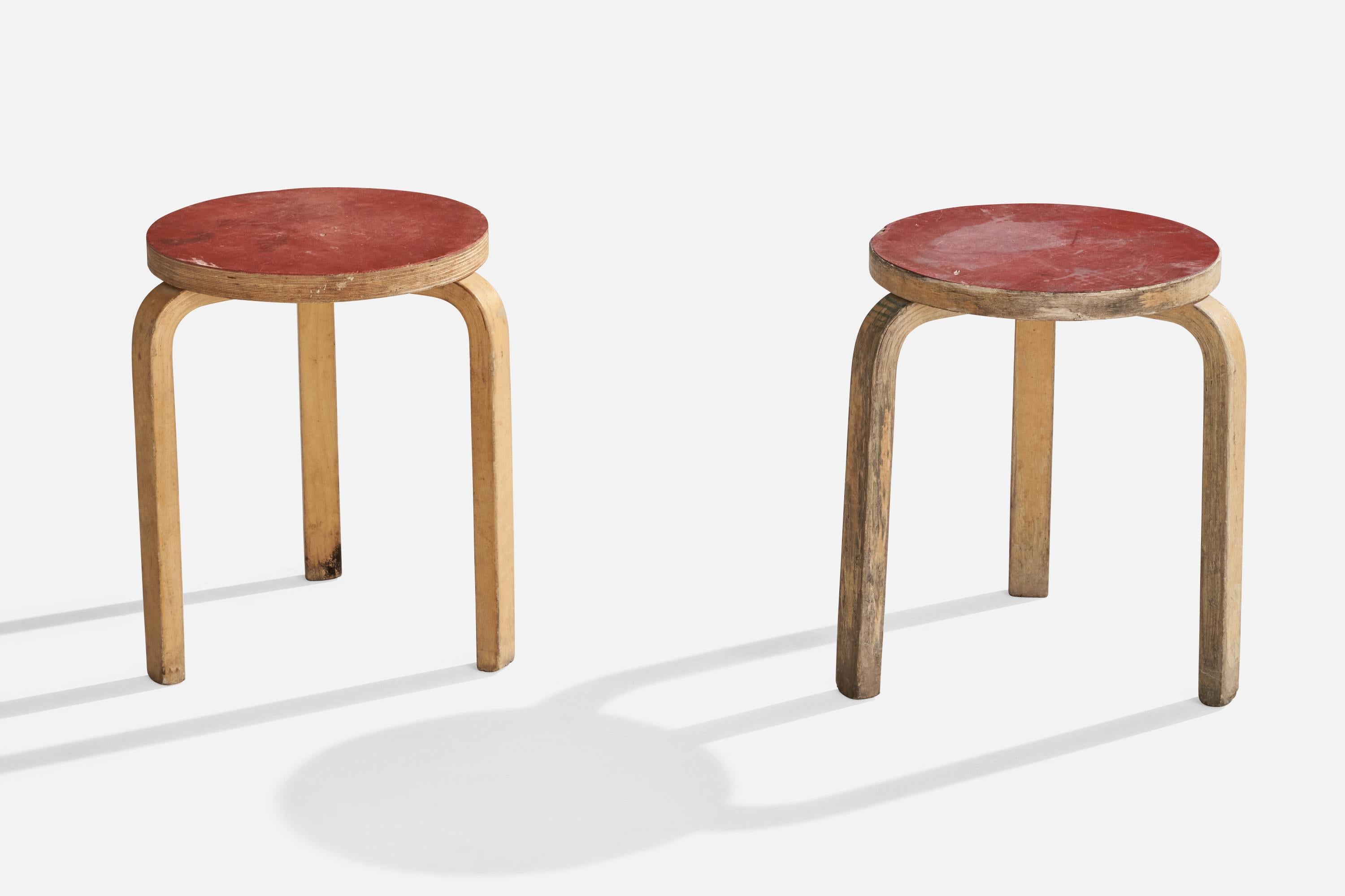 A pair of red-laminated birch stools designed by Alvar Aalto and produced by Artek, Finland, c. 1950s.

Seat height is 17.5