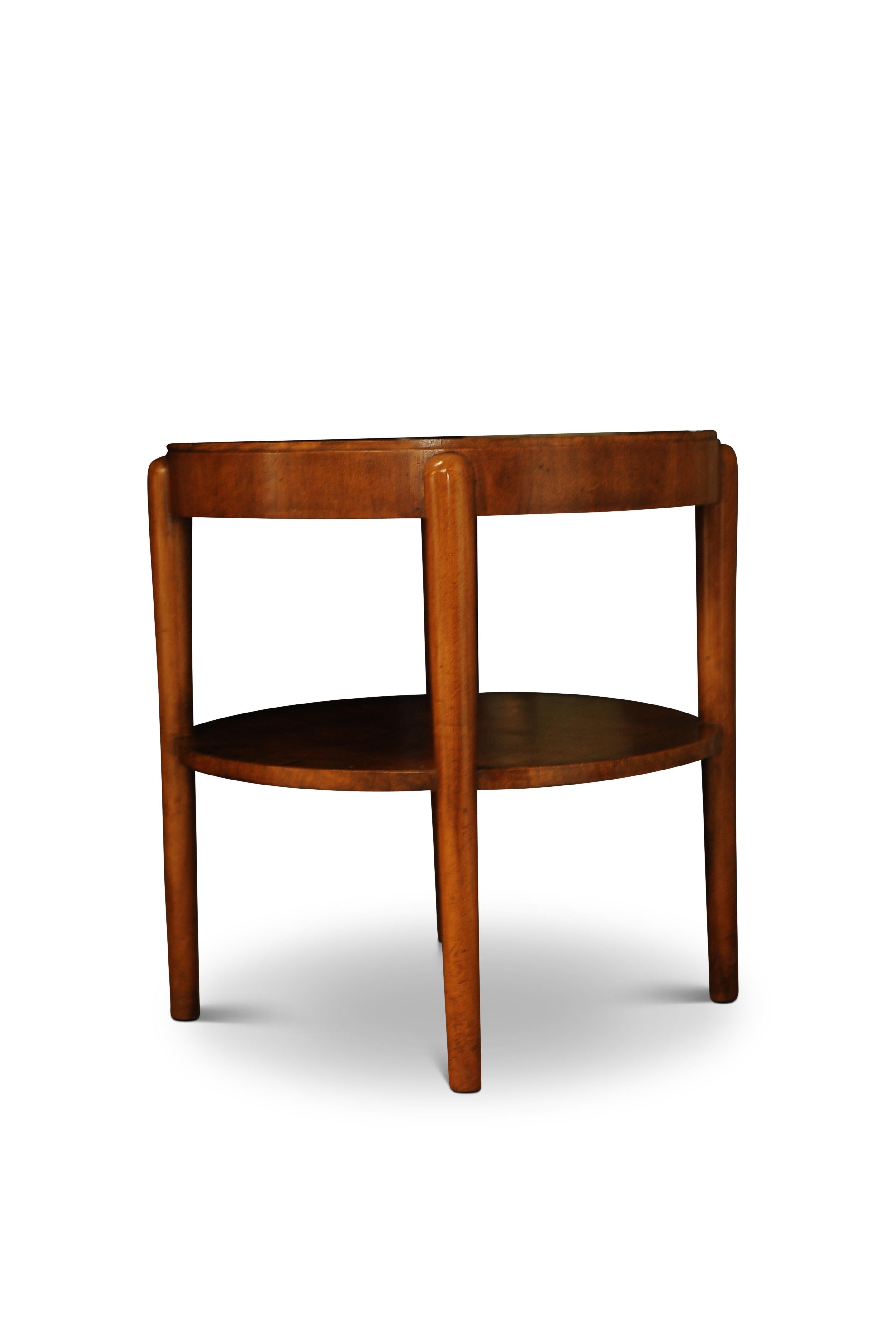 An Art Deco 1930s walnut circular cocktail table with undertier and on rounded legs in the manner of Alvar Aalto.