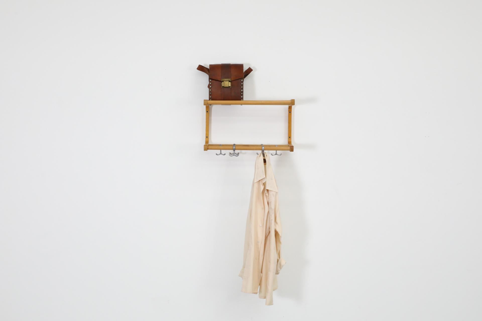 Mid-Century Alvar Aalto inspired wall mount coat rack and shelves with bent Beechwood frame. The coat rack has movable silver toned metal hooks that can slide across the lower rack. Some visible wear consistent with age and use. Other similar coat