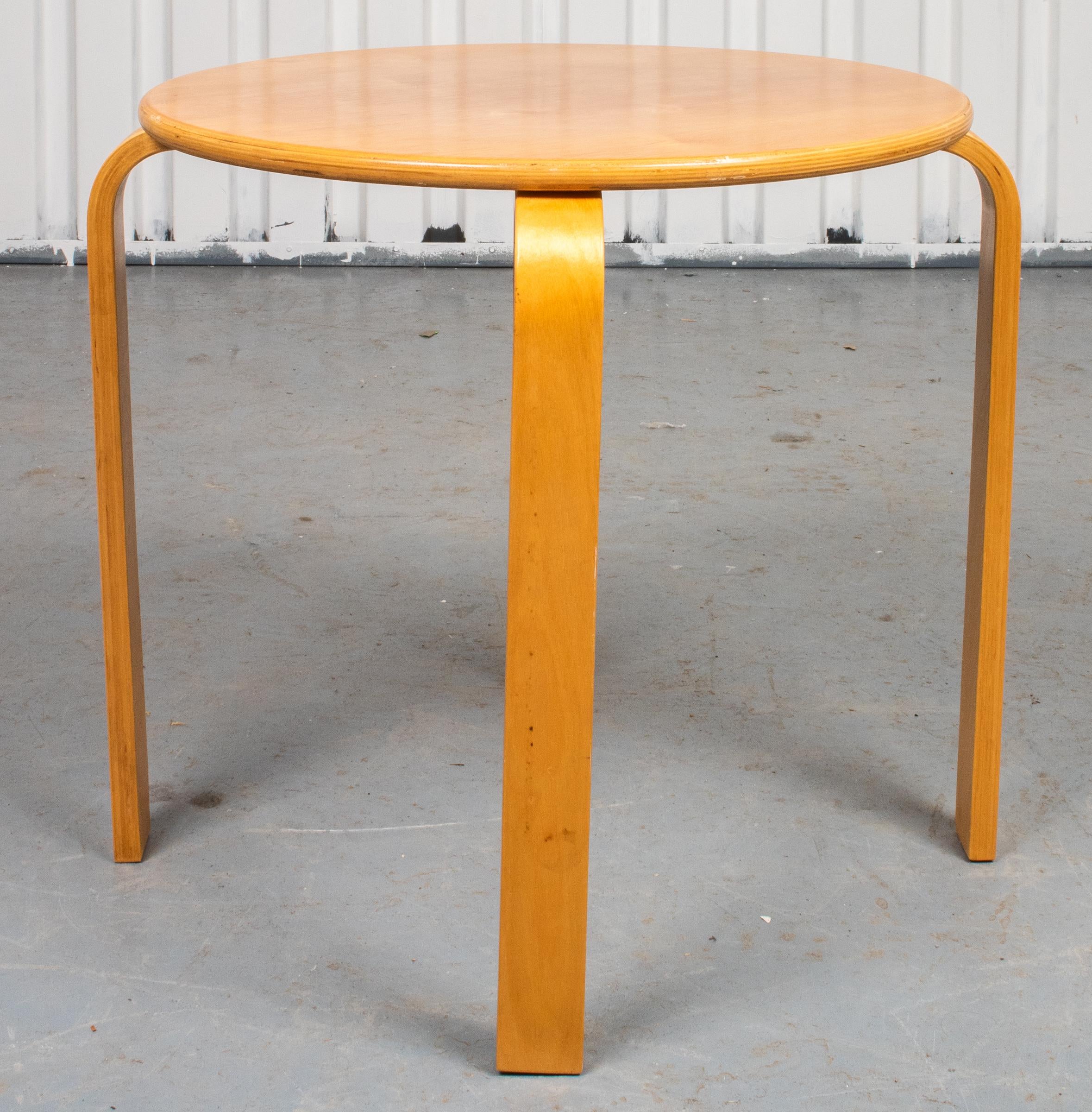 Danish Modern ashwood occasional table, after the Model 60 stacking stool by Alvar Aalto (Finnish 1898-1976), the round top over four L-form legs. Measures: 22.5