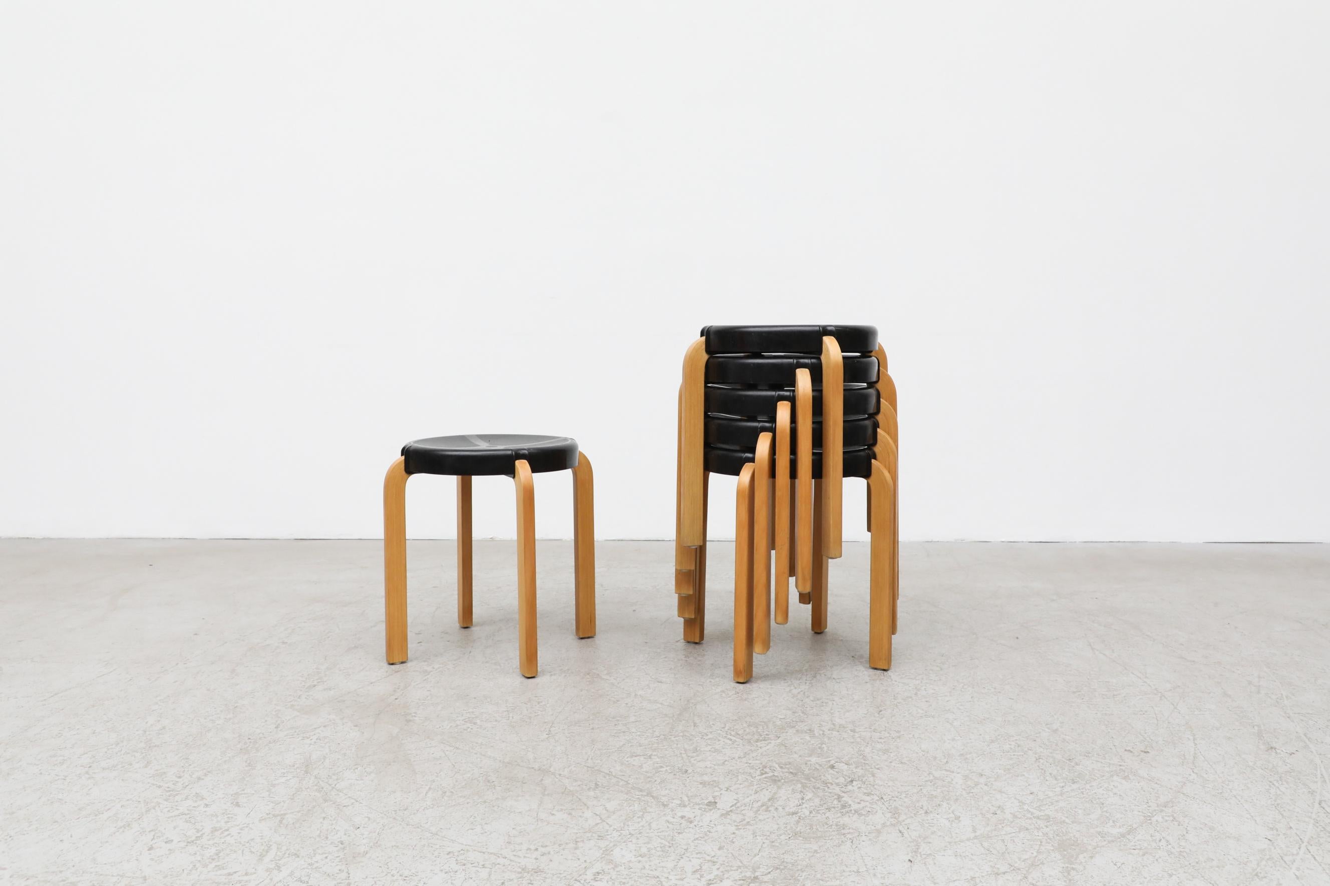 Alvar Aalto style stools with black acrylic seat by Kembo. The stools feature Aalto style bent birch legs, with molded black plastic seats. All in original condition with visible wear and patina. Wear is consistent with their age and use. Priced