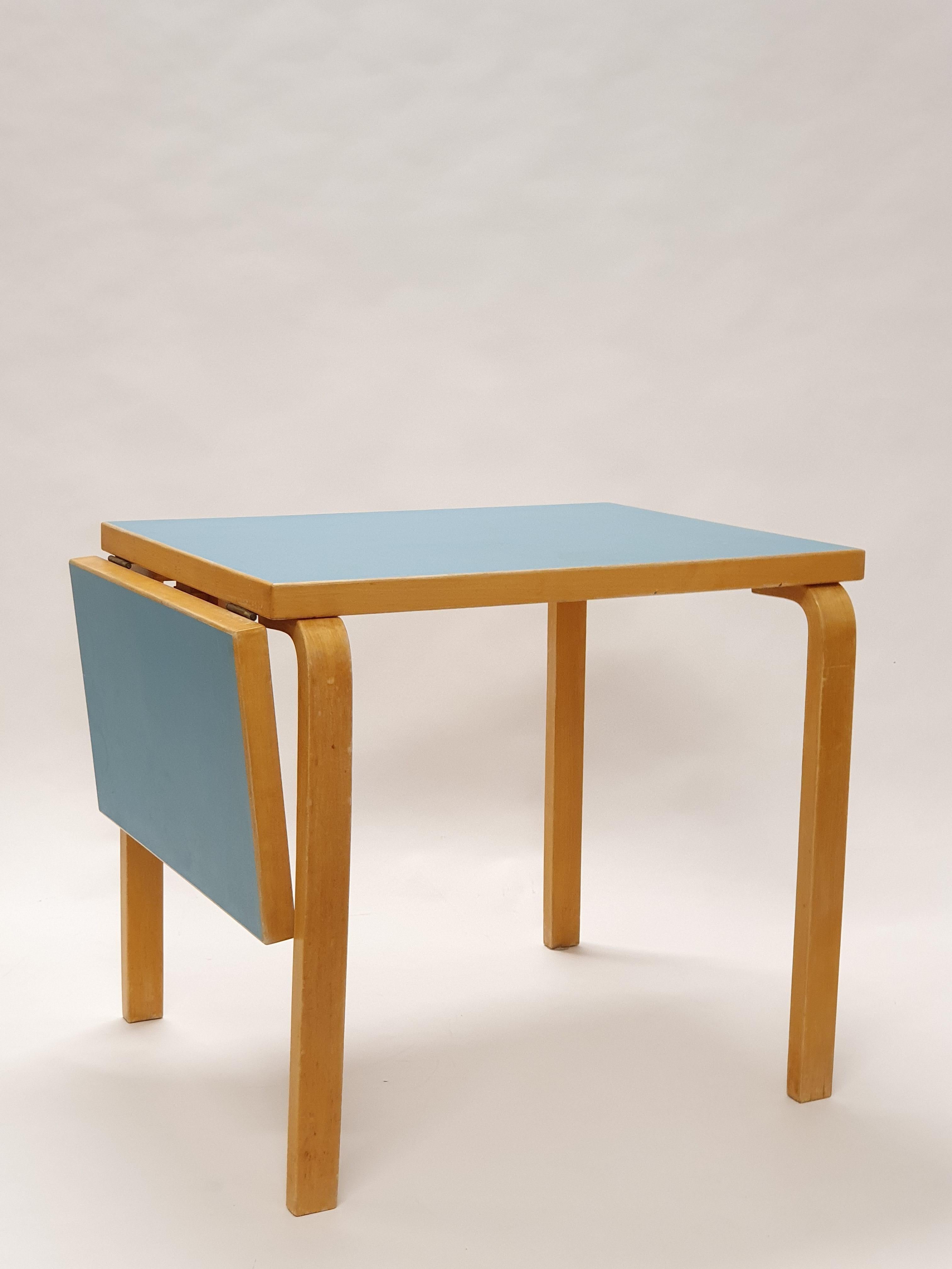 Artek table model DL82 and four chairs model 65, designed by Alvar Aalto. Both the table and chairs have light blue linoleum top. The set is from 1950s, is in good condition and has beautiful patina of age.

Size of the table top: length 80 - 115.5
