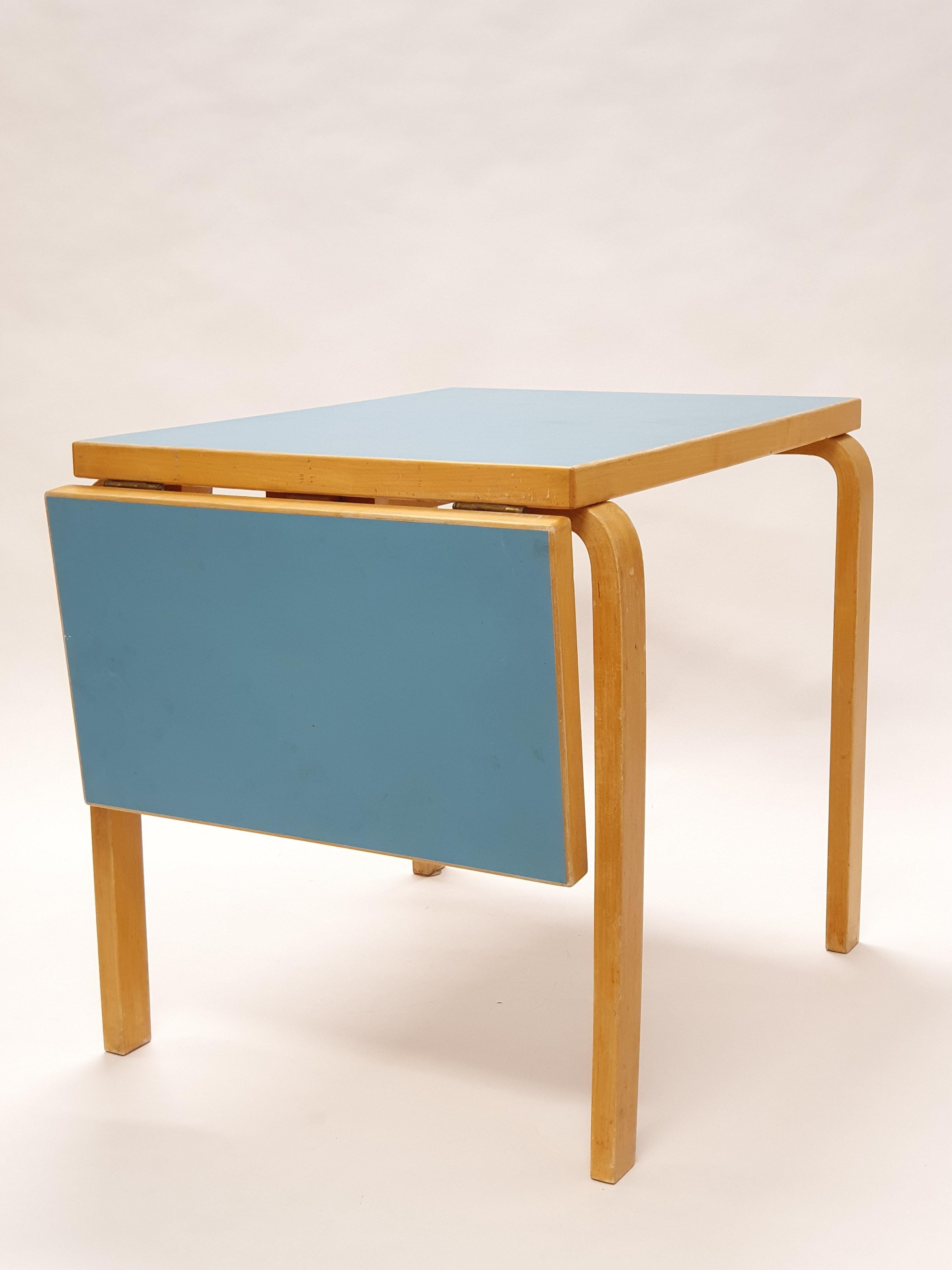Artek table model DL82, design by Alvar Aalto. The table has light blue linoleum top. The table is from 1950s, in original condition, in really good shape and has beautiful patina of age.

Size of the table top: length 80 - 115.5 cm, depth 60 cm and