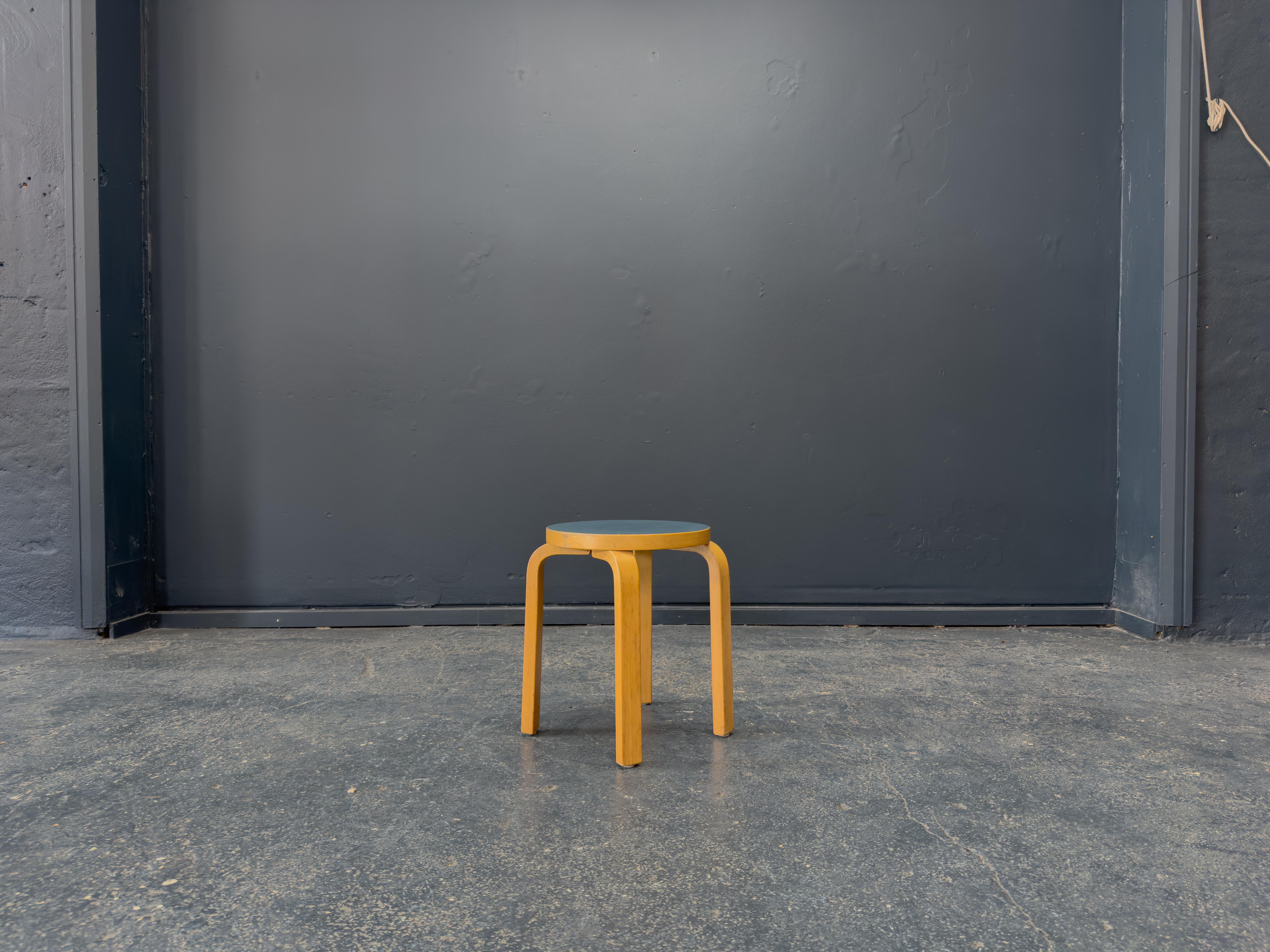 This iconic Alvar Aalto Stool is a masterclass in minimalist design and enduring craftsmanship. Aalto's celebrated bent plywood construction is on full display, with three gracefully curved birch legs that provide strength, stability, and an