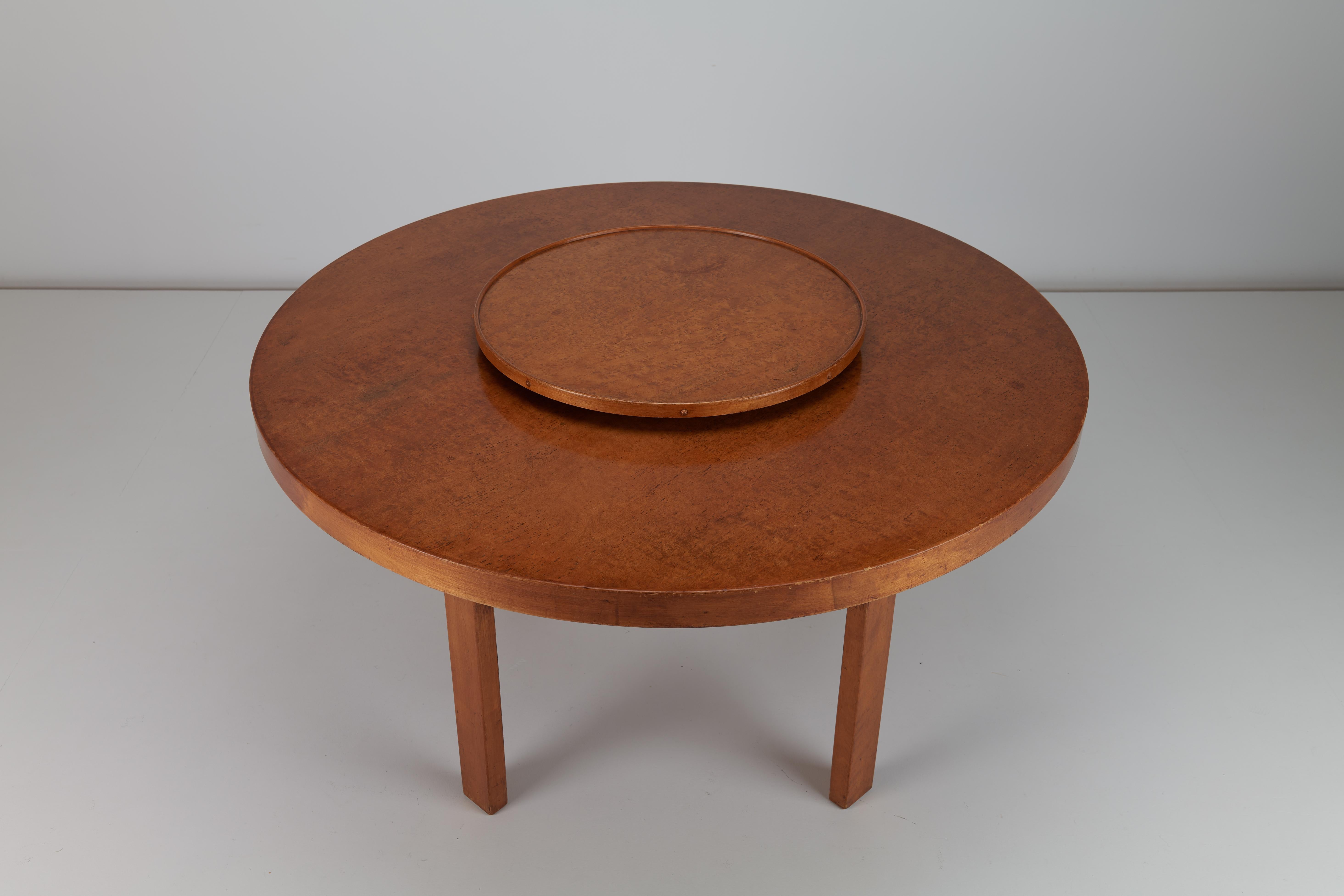 This Alvar & Aino Aalto Dining Table with Lazy Susan is a remarkable example of early twentieth century modernist design, blending functionality and elegance in one striking piece. Designed in 1933, the table features a refined combination of