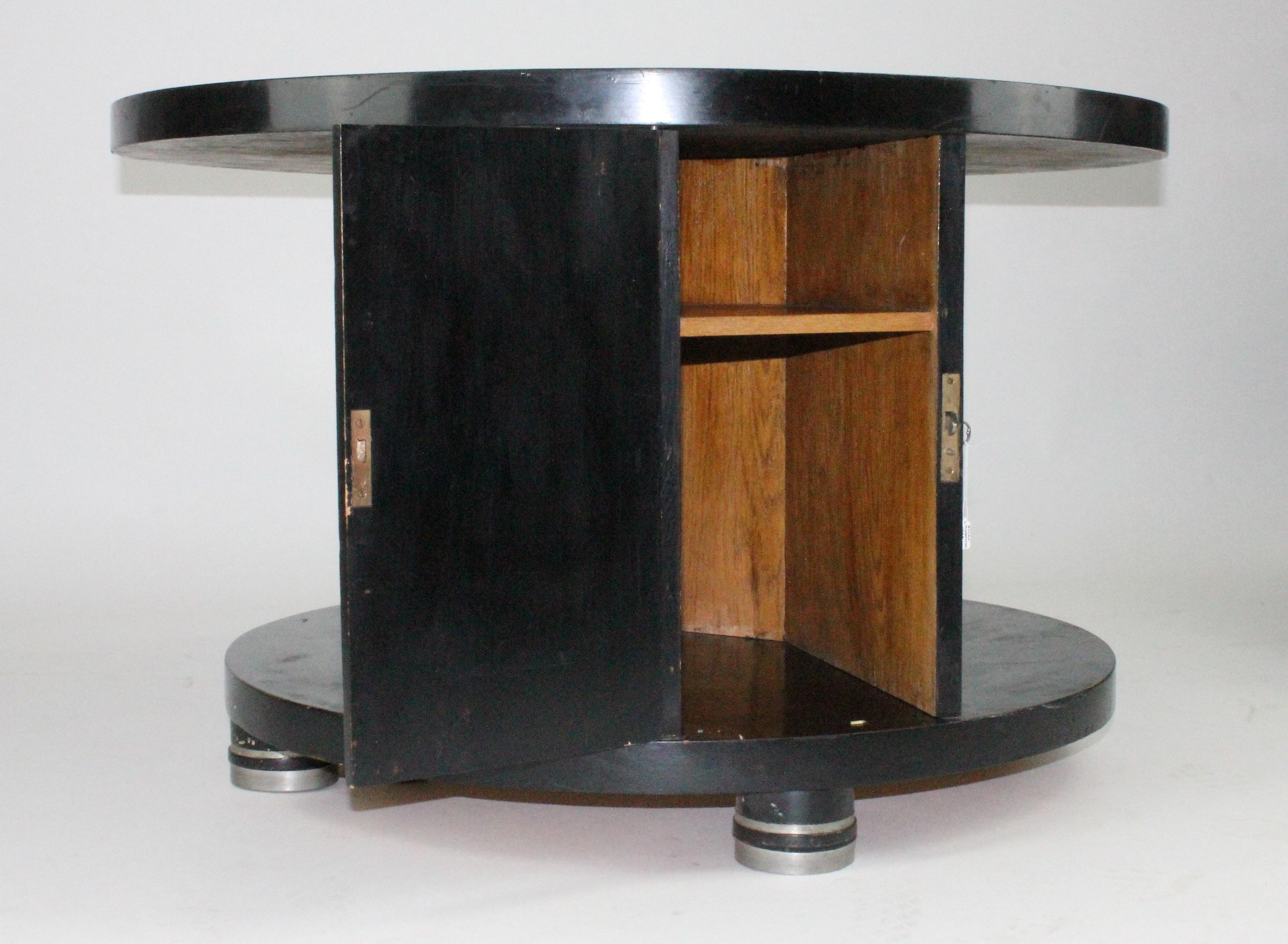 Amazing table and so rare, by Alvar Andersson for Hyresgästernas Möbelförening 1933. Black painted wood with pewter inlays. This table is unrestored! Wheels underneath, see images. One door with one shelve.