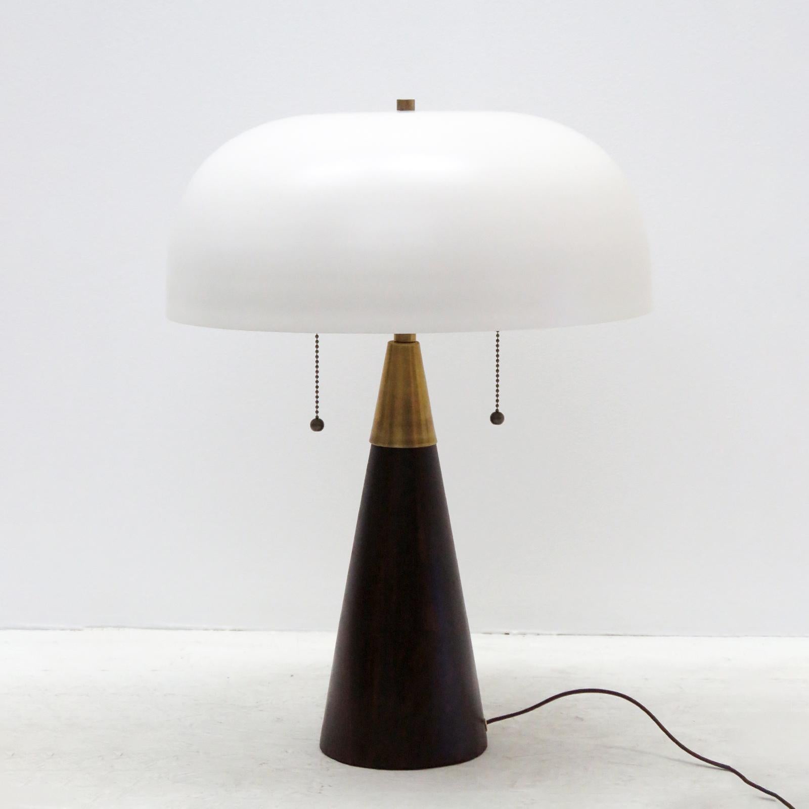 Wonderful organic modern table lamps by Alvaro Benitez for Gallery L7, with a stained wood base, a large off-white powder-coated metal shade and brass hardware. Dual bulb setup with two individual pull switches and a general in-line on/off switch.