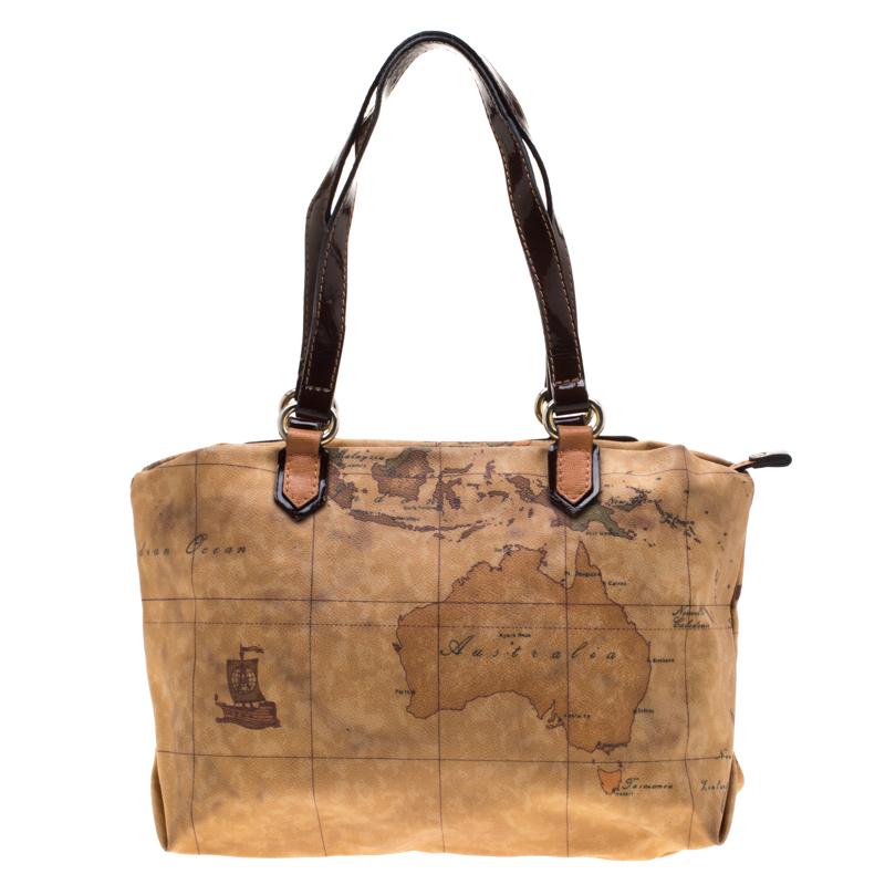 Alviero Martini 1A Classe brings to you this geo printed coated canvas tote. The tote comes with an interesting exterior along with dual handles, leather panel and zip detail to the front. The nylon-lined spacious interior will hold all your