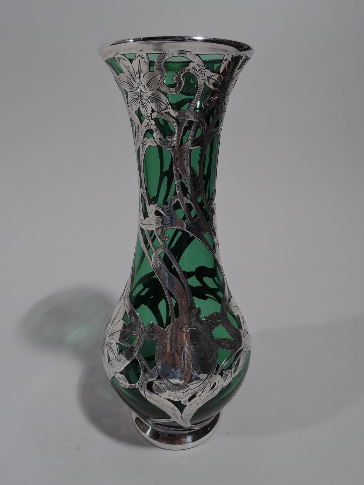 Turn-of-the-century Art Nouveau green glass vase with engraved silver overlay. Made by Alvin in Providence. Gentle baluster with flared rim and inset foot in silver collar. Climbing, twisting, and entwining stems and tendrils with blooms Scrolled
