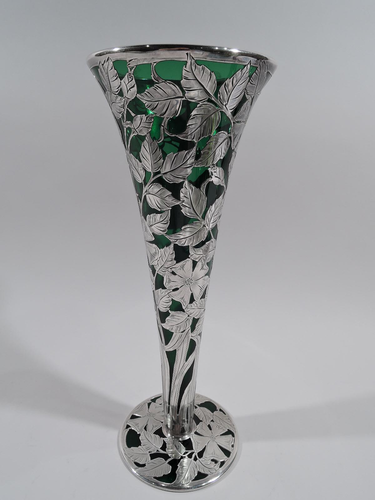 Turn-of-the-century Art Nouveau glass vase with engraved silver overlay. Made by Alvin in Providence. Conical on flat round foot. Dense vertical overlay in form of entwined tendrils and leafing and flowering branches. Glass is dark green. Pontil