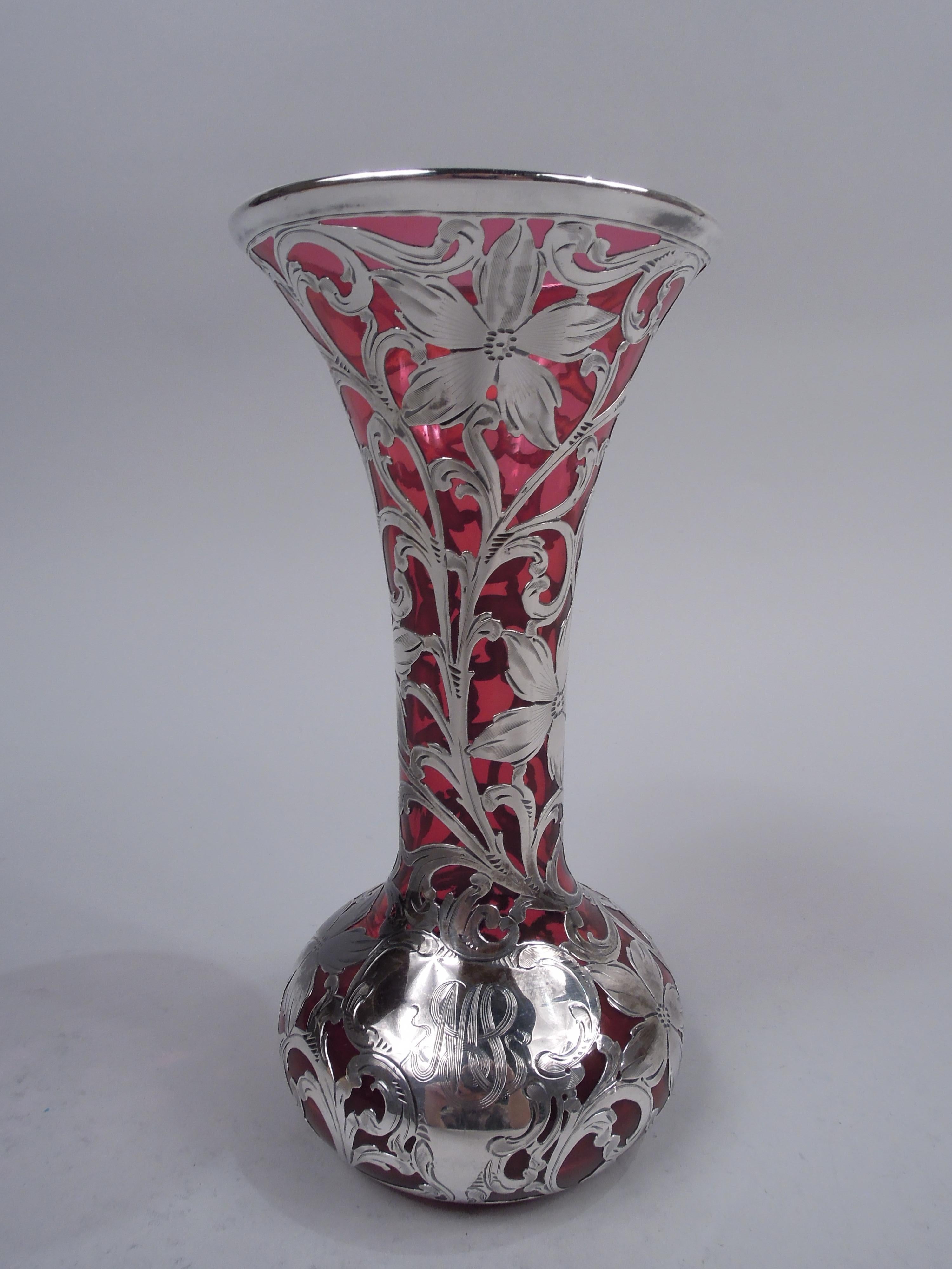 Art Nouveau glass vase with engraved silver overlay. Made by Alvin Corp. in Providence, ca 1900. Conical mouth and neck, and bellied bowl. Overlay in form of dense leafing scrollwork and flowers; asymmetrical scrolled cartouche engraved with