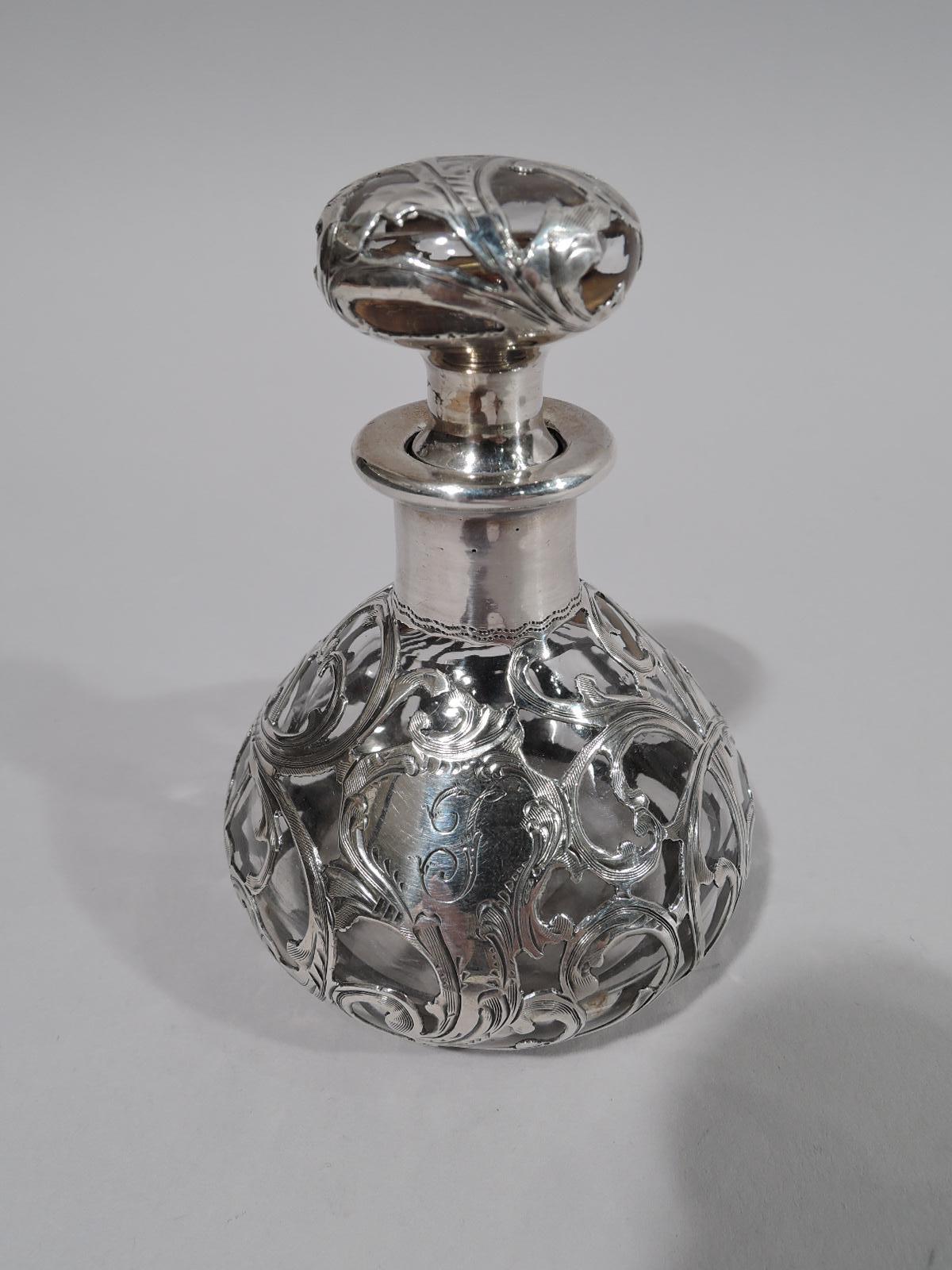 Sweet and pretty Art Nouveau clear glass perfume with silver overlay. Made by Alvin in Providence, circa 1900. Bottle ovoid with short cylindrical neck and flat rim in silver collar. Stopper squashed ball with short plug. Engraved silver overlay in