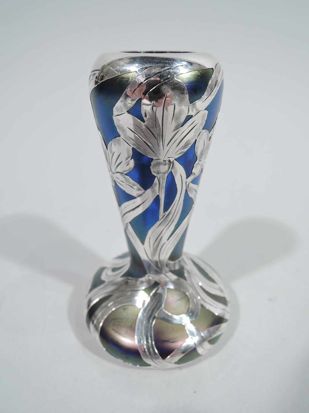 Turn-of-the-century Austrian Art Nouveau glass vase with engraved silver overlay. Tapering neck with curved shoulder and round inset mouth, and bellied base. Overlay in form of stem flowers with whiplash and interlaced tendrils. Glass iridescent in