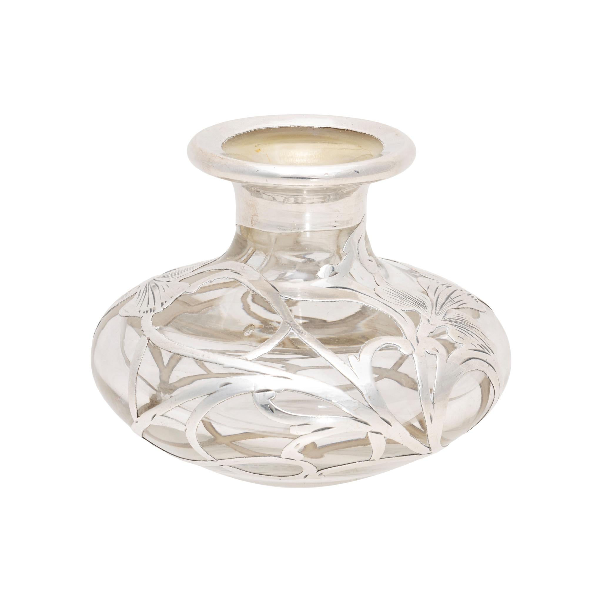Alvin silver overlay glass perfume bottle. With clear glass and art nouveau style silverwork, featuring two irises. Center is monogrammed with a gothic style 