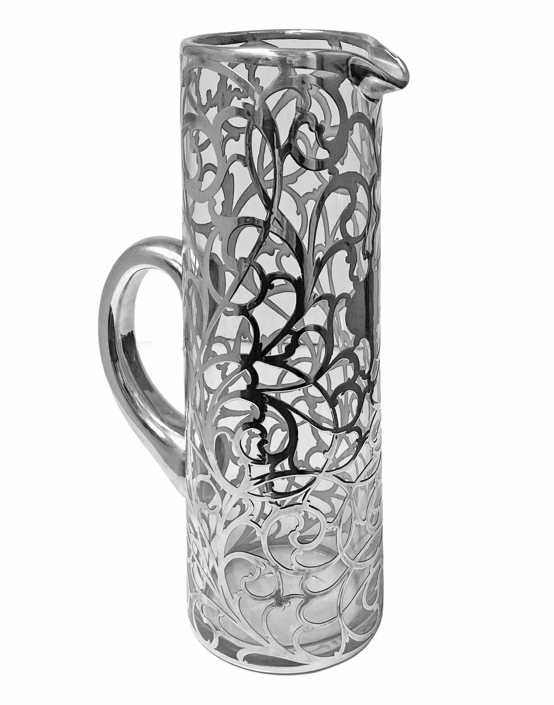 Alvin sterling overlay clear glass jug pitcher, c. 1900. Large size tapered cylindrical, with thick applied sterling silver overlay, reticulated and engraved scrolling vine, central vacant cartouche. Rubbed Alvin Corp marks to base rim 999/1000 Fine