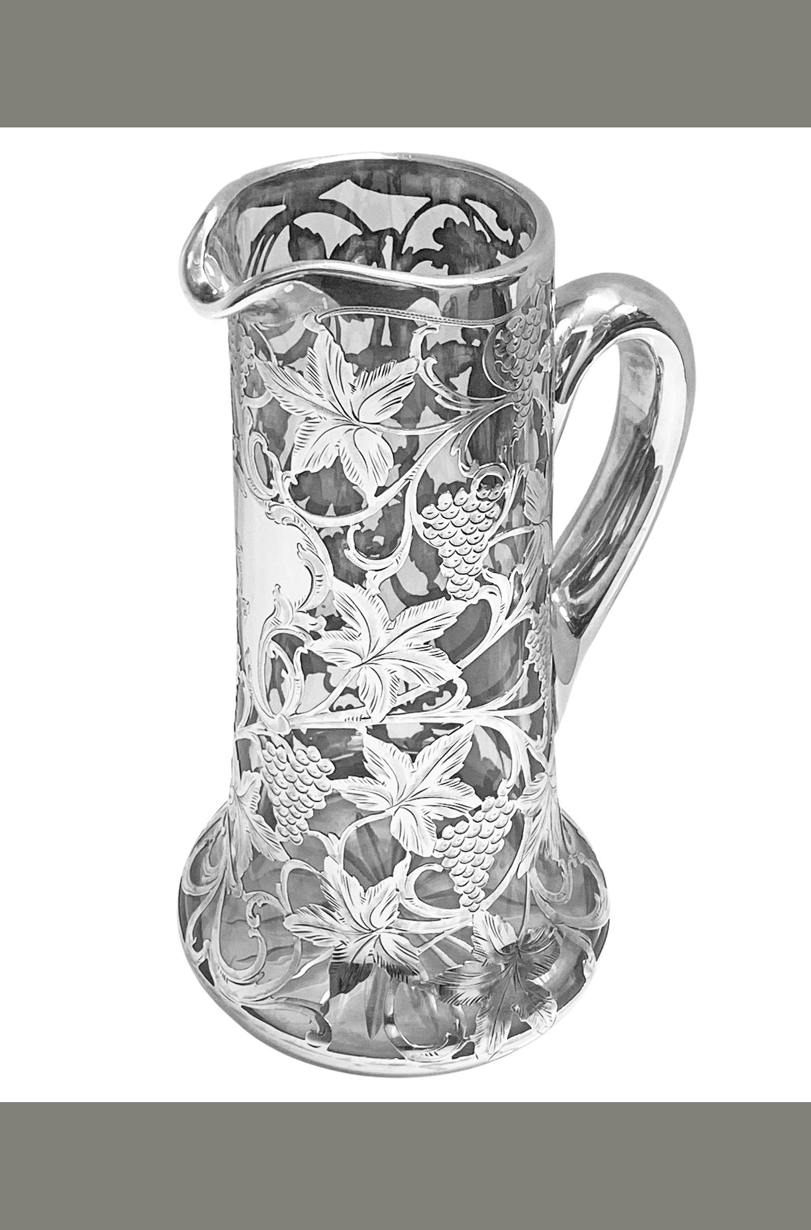 Alvin sterling overlay glass jug pitcher, c. 1900. Tapered cylindrical, very fine thick overlay sterling silver with engraved scrolling vine, central vacant cartouche. Marked under handle Patented 3834, 999 over 1000 Fine and maker's mark for Alvin