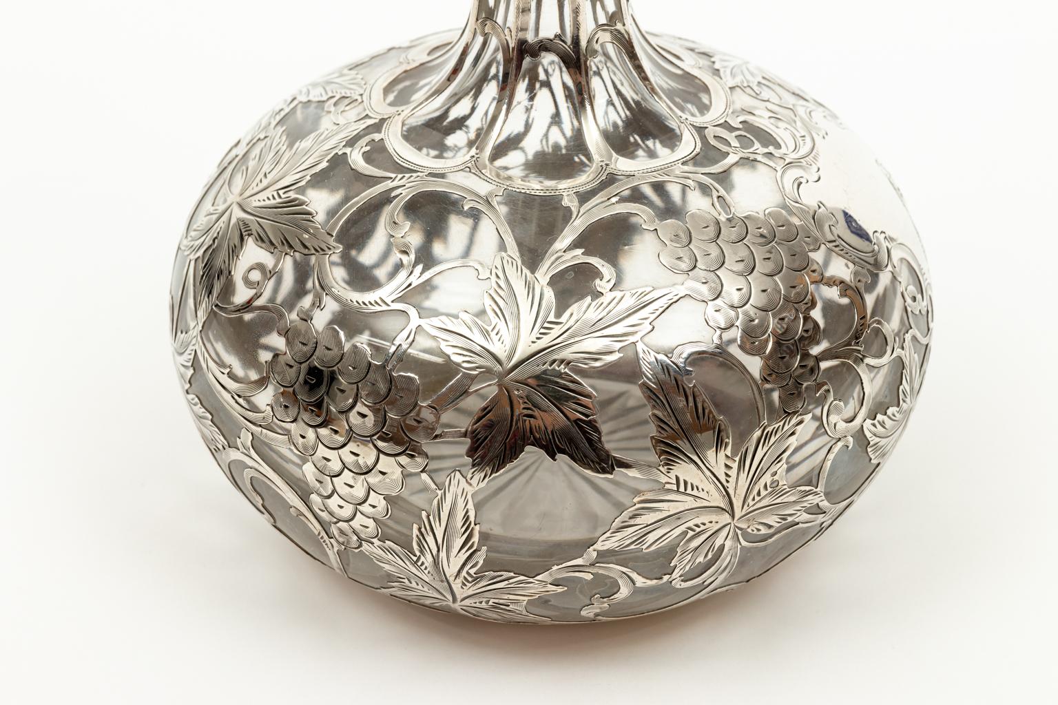 Circa 1900-1920s Alvin sterling 999/1000 fine 11.00 inch high decanter. Bulbus base, one thin neck, cartouche, no monogram. Grape and fern design. Sterling overlay on crystal. Made in the United States. Please note of wear consistent with age.