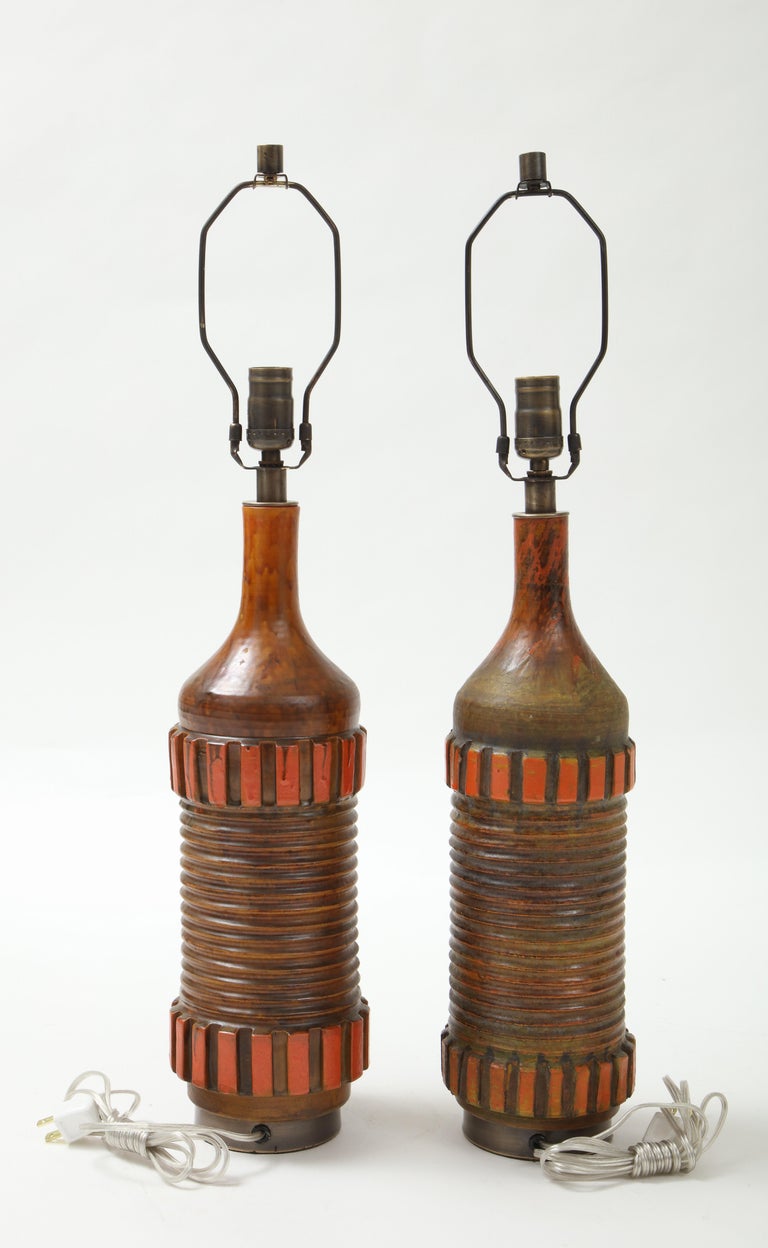 Exquisite pair of Italian Modernist ceramic lamps in a mottled dark brown/orange matte glaze on custom bronze bases. Rewired for use in USA. 100W max.