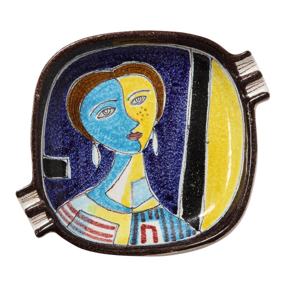 Alvino Bagni for Raymor ashtray, Ceramic, cubist, blue, yellow, signed. Rounded square ashtray decorated with a highly stylized cubist woman and glazed in yellow, light and navy blue, and black. Signed Italy 072149 on the underside. Bagni was a
