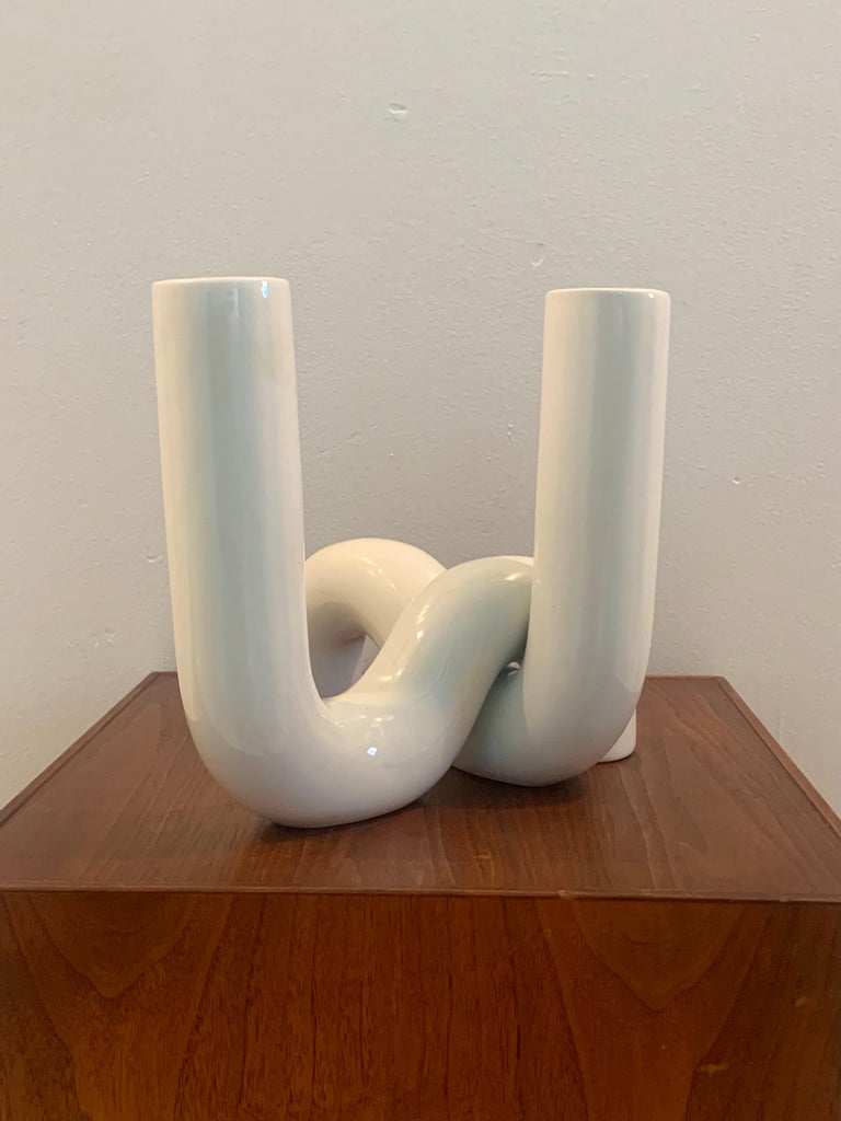 Pair of vases designed by Alvino Bagni for Raymor. White ceramic curved tubes that can be set up in a variety of ways. The spacing of the curve allows for the vases to be interlocked into one piece, or keep them separate as a pair of vases.