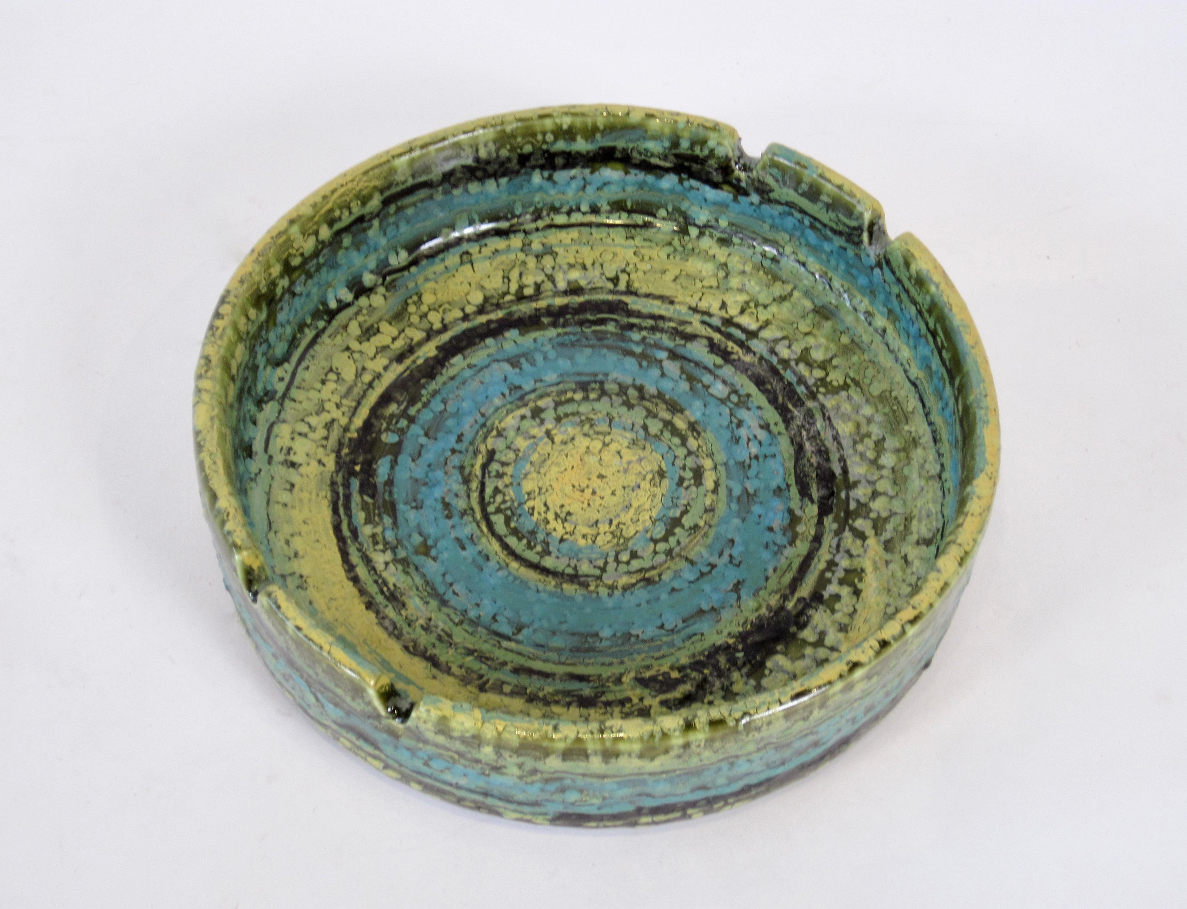 Alvino Bagni Italian pottery ashtray imported by Raymor in very clean condition without any chips or cracks. 
Concentric color swirls in green, yellow, turquoise and black and textural finish make this pedestal ashtray a mid century standout.

I