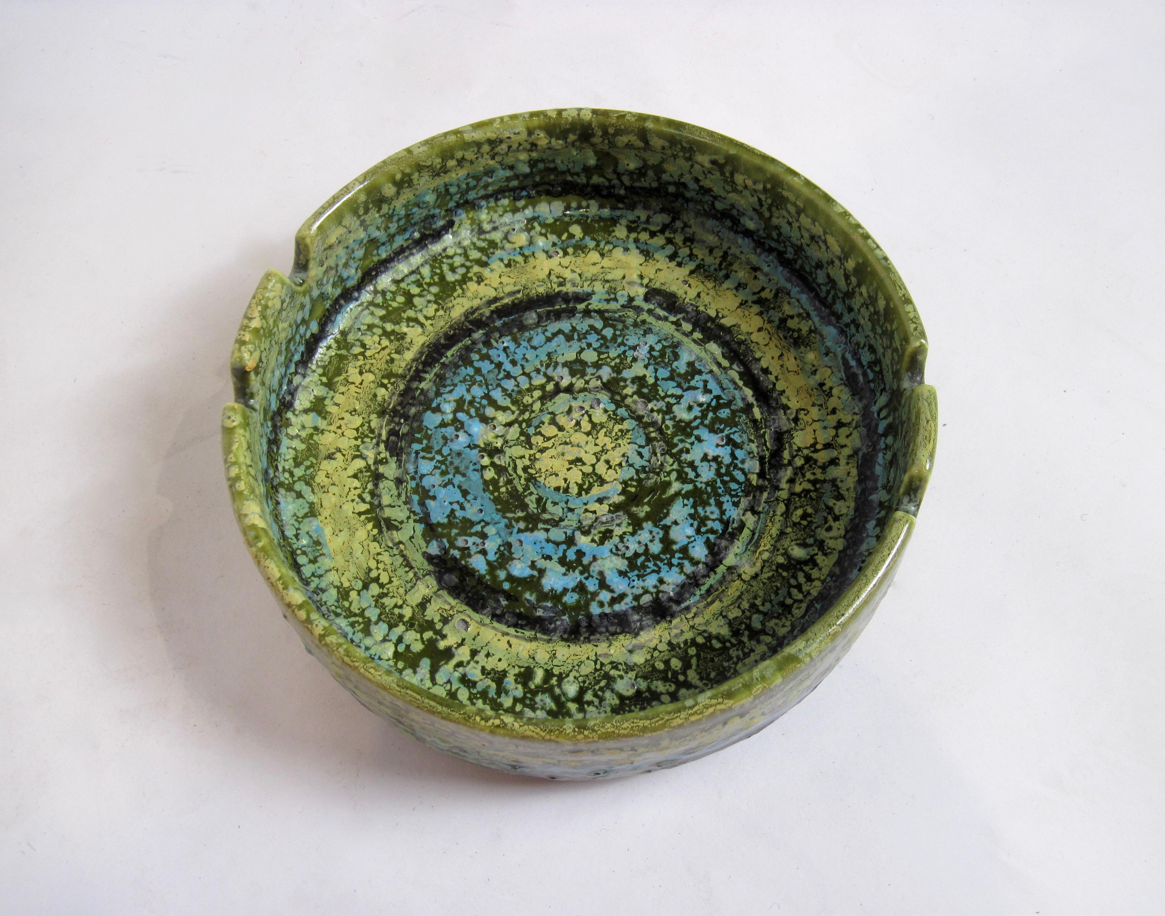 Alvino Bagni Italian pottery ashtray imported by Raymor in very clean condition without any chips or cracks. 
Concentric color swirls in green, yellow, turquoise and black and textural finish make this pedestal ashtray a mid century standout. 
I