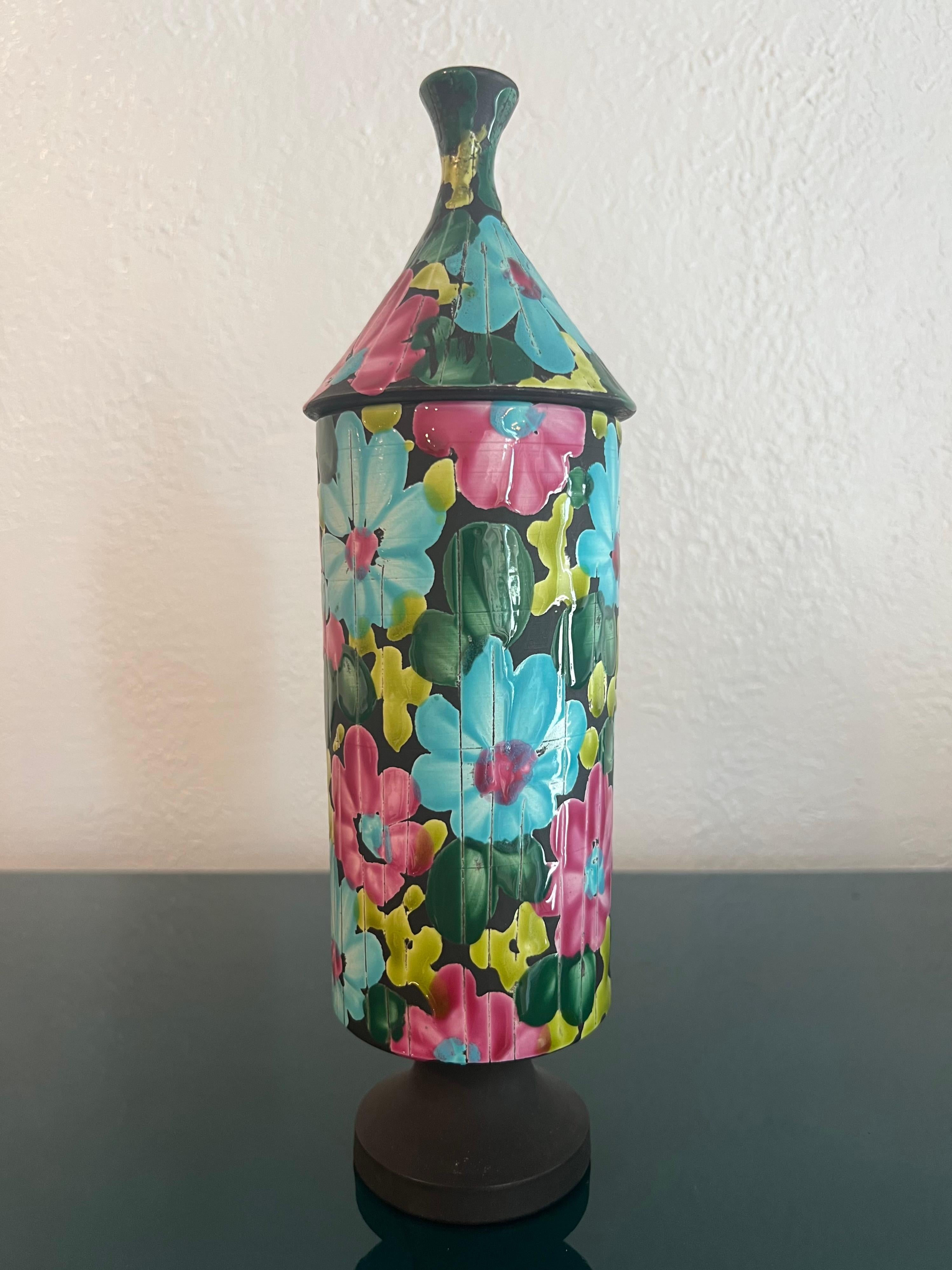 Alvino Bagni lidded vase in a brilliant floral design. Small area on base where glaze did not catch (please refer to photos). Additional photos available upon request.

Would work well in a variety of interiors such as modern, mid century modern,