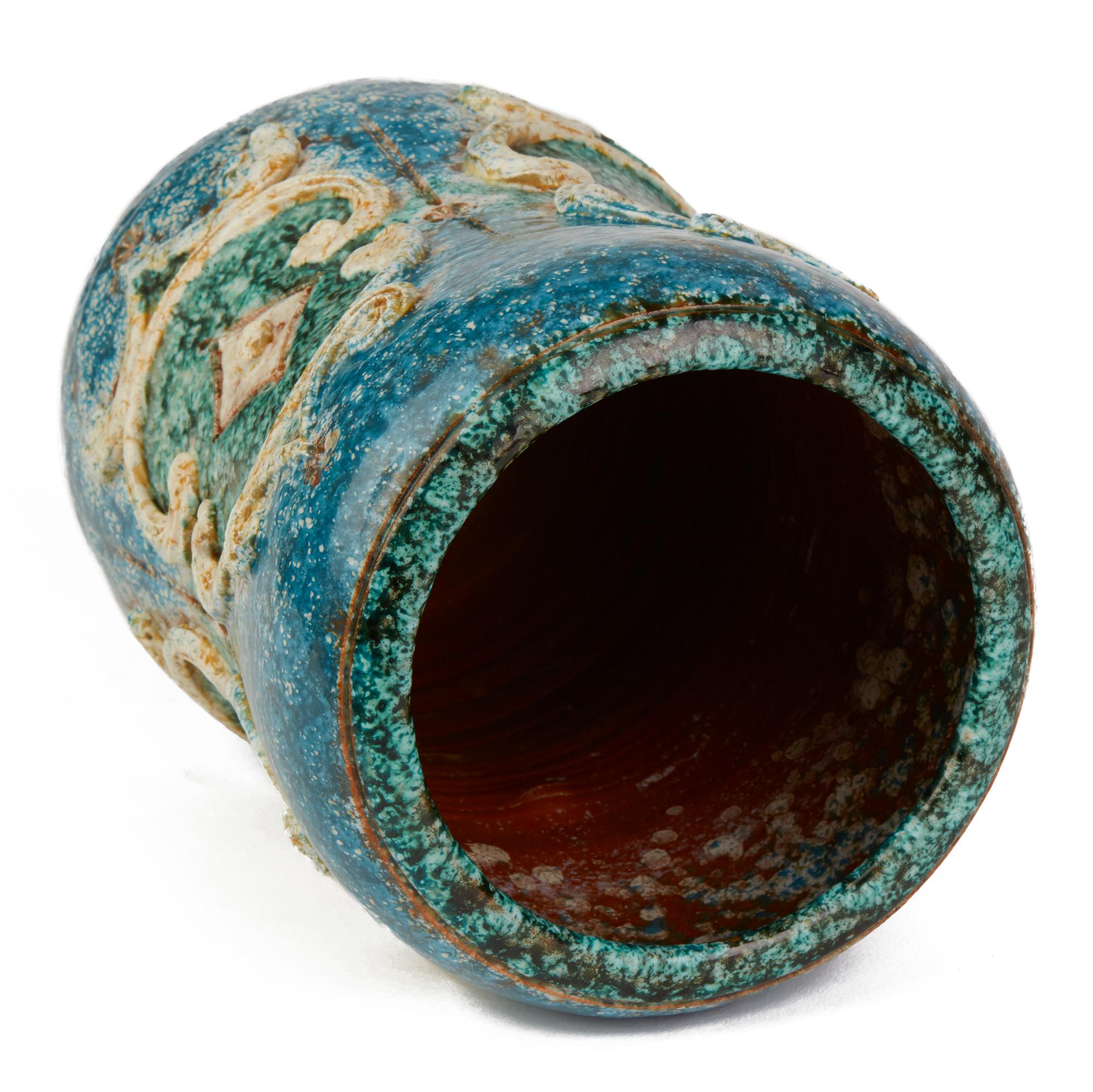 A very unusual and stylish vintage Italian art pottery vase attributed to Alvino Bagni and probably made by Raymor. The waisted rounded bulbous vase is applied with raised designs with incised patterning and decorated in sea colored glazes with