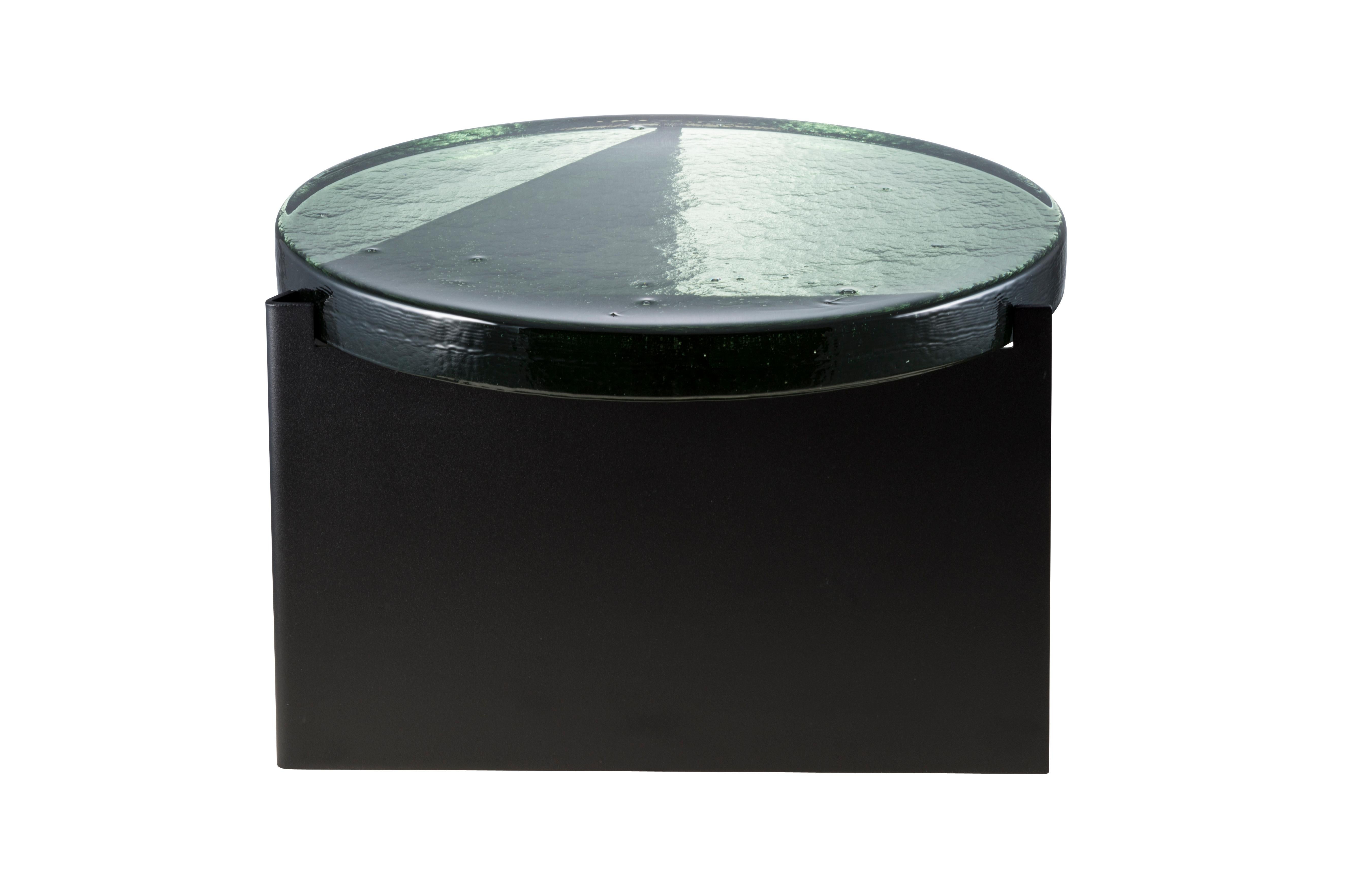 Alwa one big green black coffee table by Pulpo.
Dimensions: D56 x H35 cm.
Materials: casted glass; powder coated steel 

Also available in different finishes.

Normally, glass is regarded as being lightweight with sharp edges. In contrast,