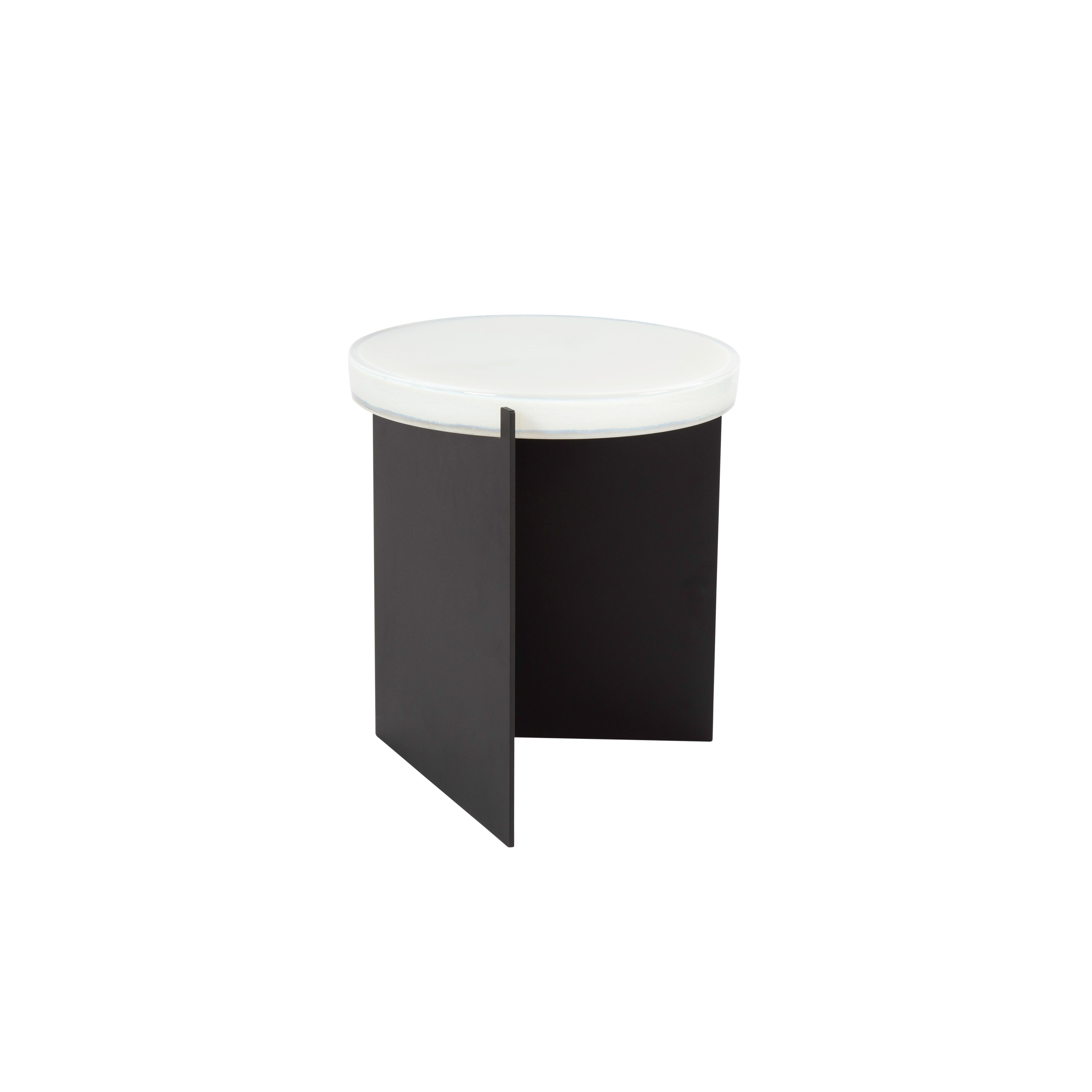 Alwa one white black side table by Pulpo.
Dimensions: D38 x H44 cm.
Materials: Casted glass; powder coated steel. 

Also available in different finishes. 

Normally, glass is regarded as being lightweight with sharp edges. In contrast,