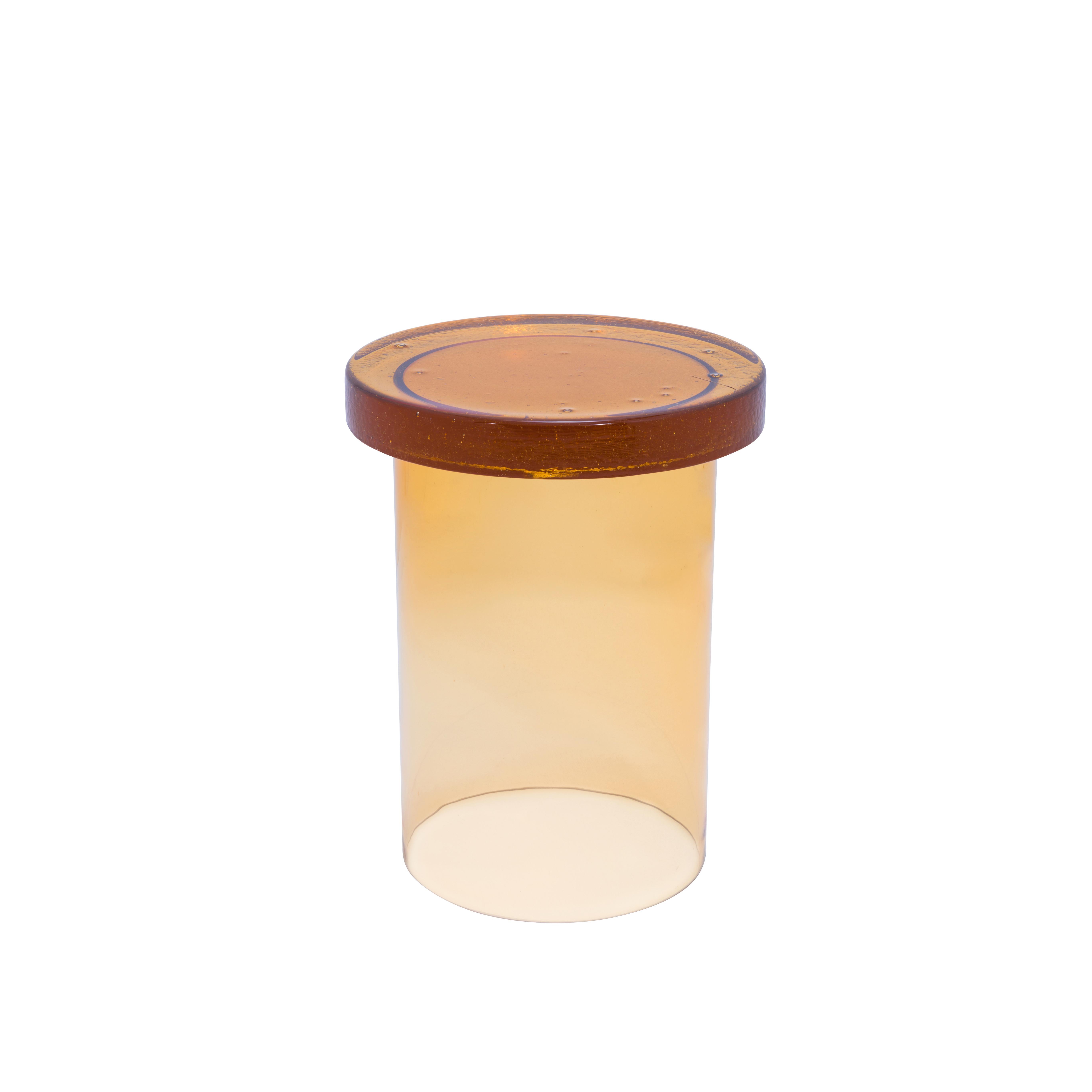 Alwa three amber side table by Pulpo
Dimensions: D 38 x H 44 cm
Materials: casted and handblown glass

Also available in different colours.

Normally, glass is regarded as being lightweight with sharp edges. In contrast, Sebastian Herkner’s