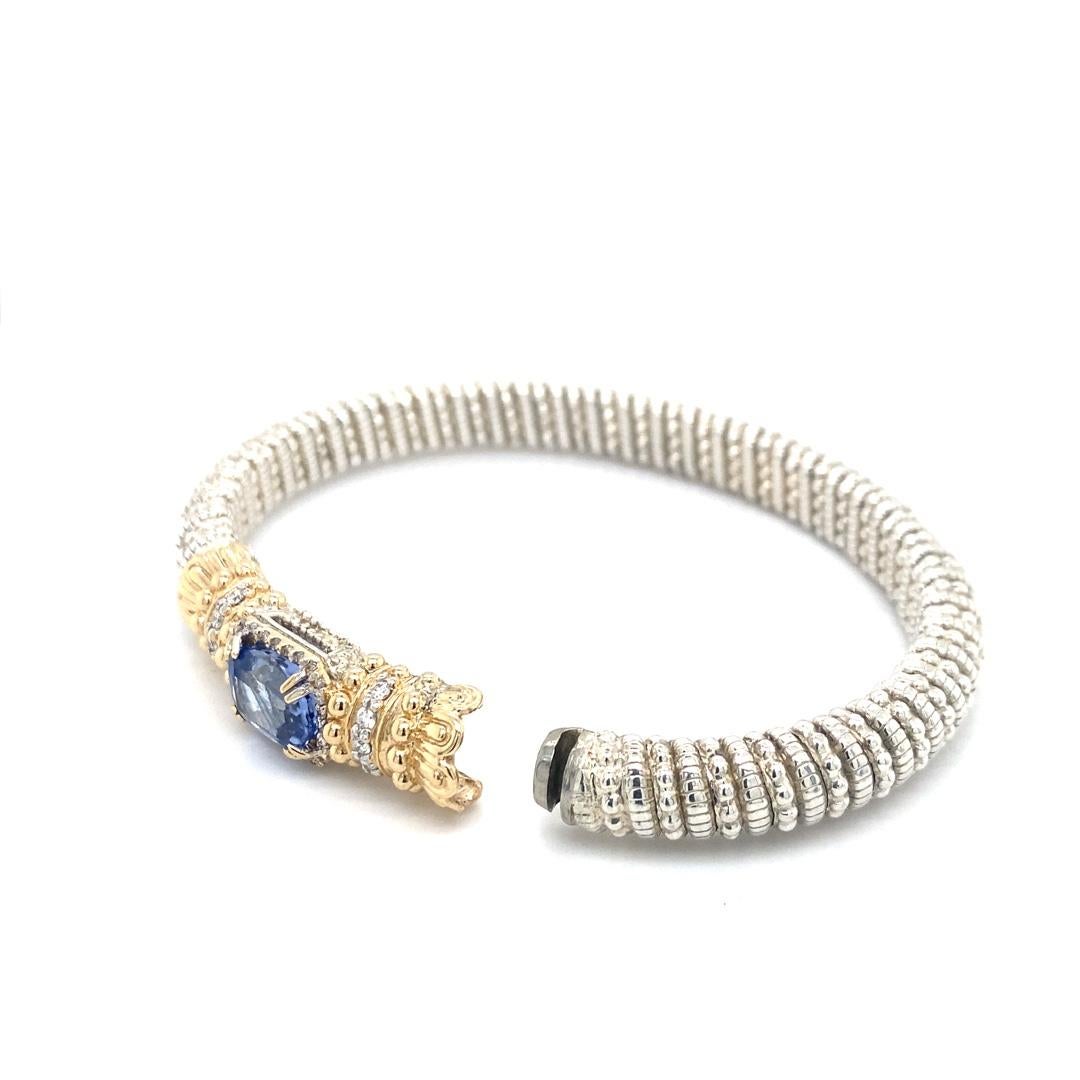 This handcrafted bracelet is made by Alwand Vahan. The bracelet is sterling silver with 14 karat gold accents. There is 0.33cttw of diamonds. The bracelet is 8mm wide with a 7