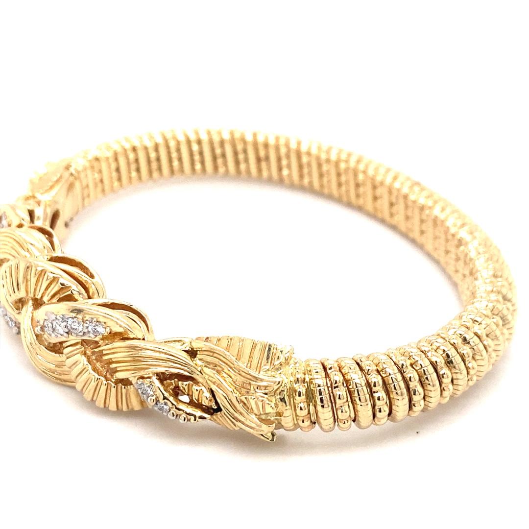 This handmade bracelet is designed by Alwand Vahan. There is 0.40cttw of diamonds set in 14 karat yellow gold. The bracelet features a woven design with a beaded pattern, measuring 8mm wide and fitting a 7