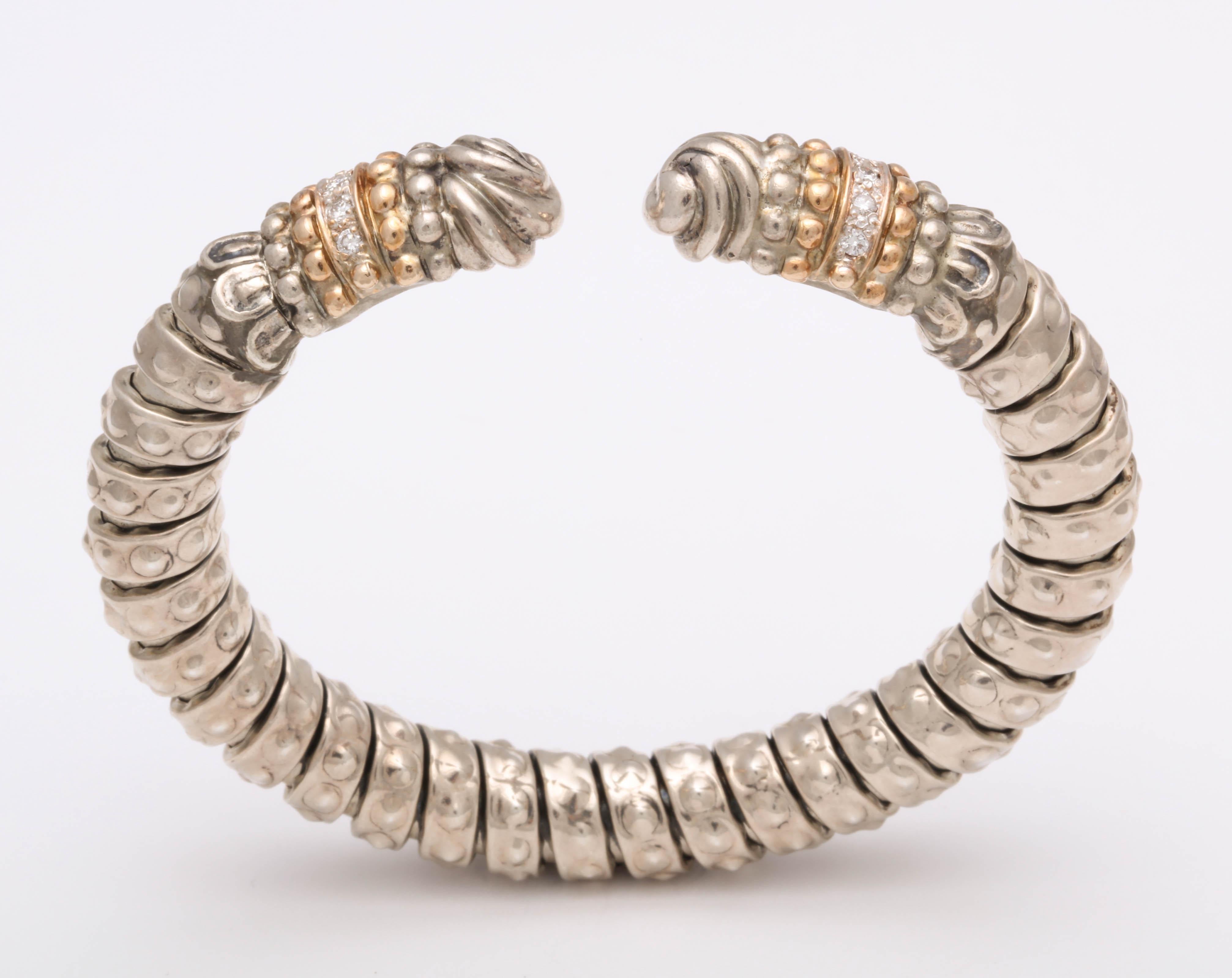 Luxurious Sterling Silver segmented Bangle with  three  14kt Yellow Gold Beaded Terminals - The two separated by  a single  row of full cut Diamonds on either side. of the Bangle.
Signed A Vahan 14kt & Sterling.  Lovely by itself or mixed with
