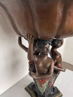 Bronze riser with 20th century putti sculpture